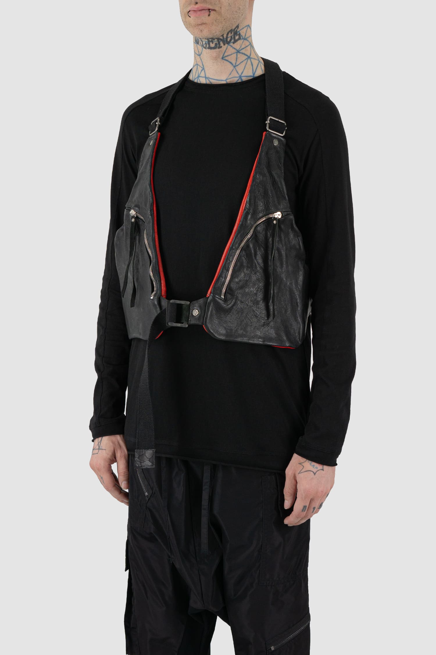0.Hide - front side view of vegetable tanned black and red horsehide leather cargo vest from the permanent collection with two types of horse leather shoulder panels, adjustable cotton straps and zippered pockets.