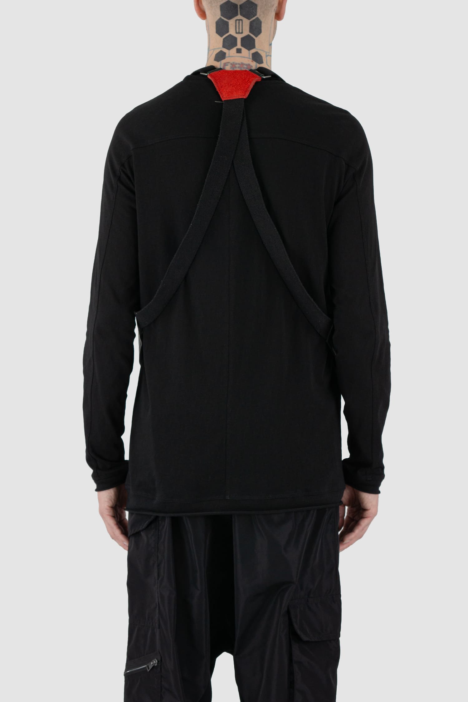 0.Hide - back model view of vegetable tanned black and red horsehide leather cargo vest from the permanent collection with two types of horse leather shoulder panels, adjustable cotton straps and zippered pockets.