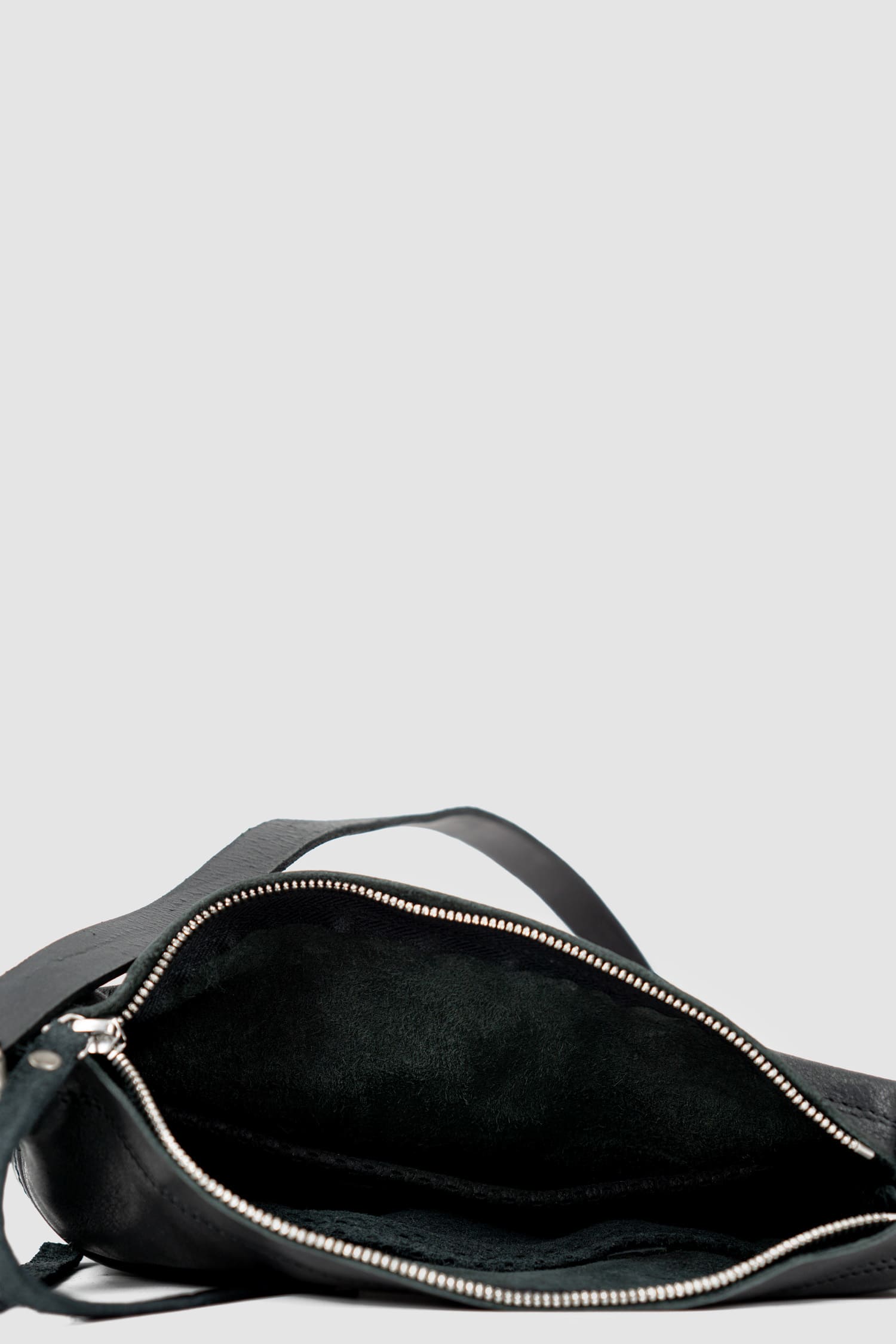 0.Hide - inside view of black leather Essential Messenger Bag.