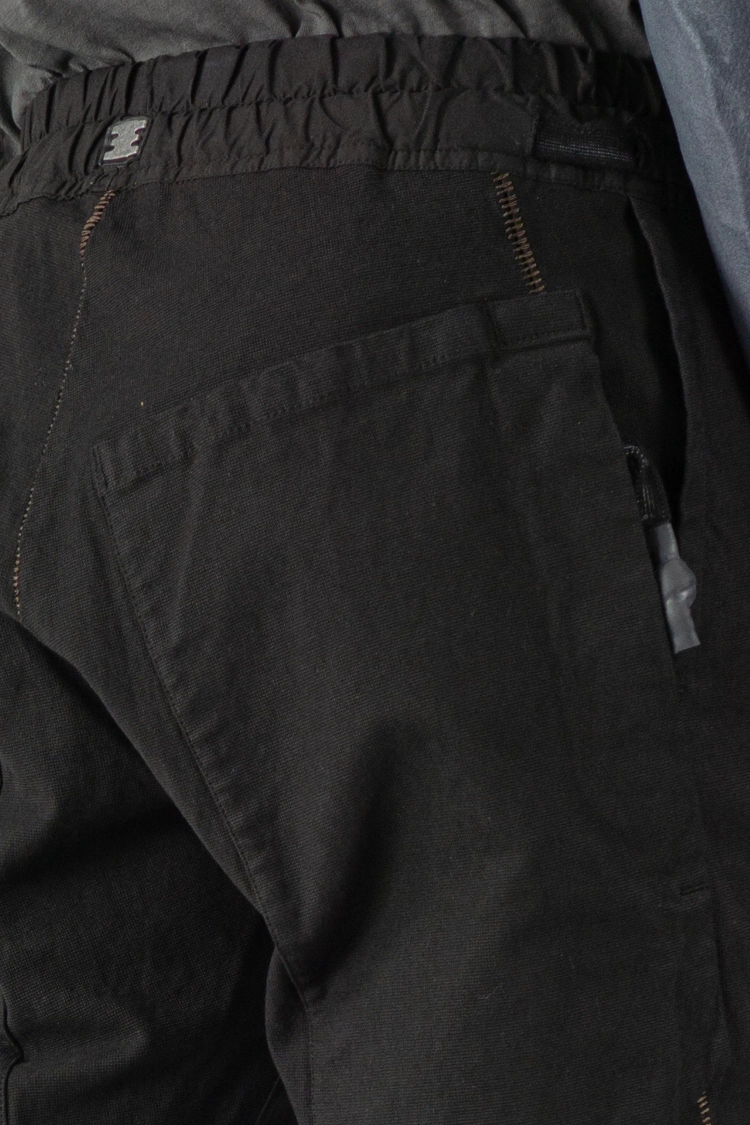 69 by Isaac Sellam - model pocket detail of Black Fitted Cotton Cargo Trousers