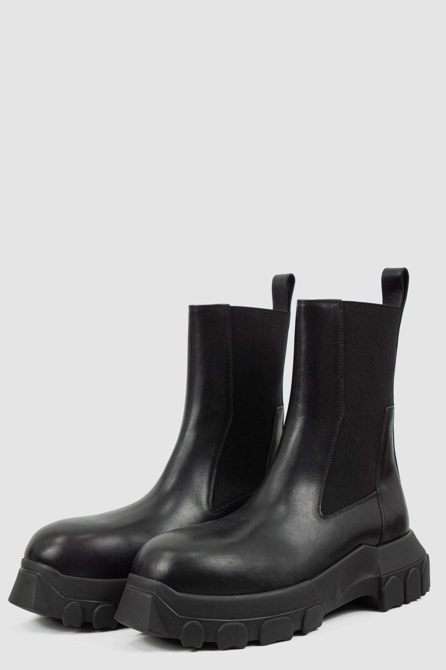 Rick Owens Black Bozo Tractor Boots for Men from the FW21 Collection with Elastic Rubber Band and pull tab Detail, front right.