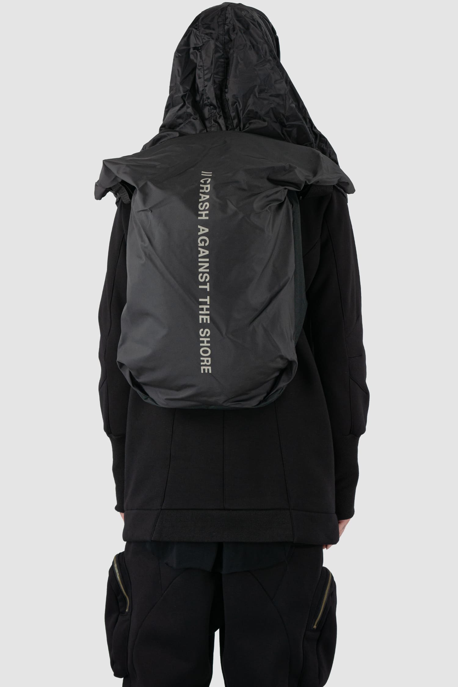 First Aid to the Injured - back cape view of black -Crash against the shore- utility backpack.