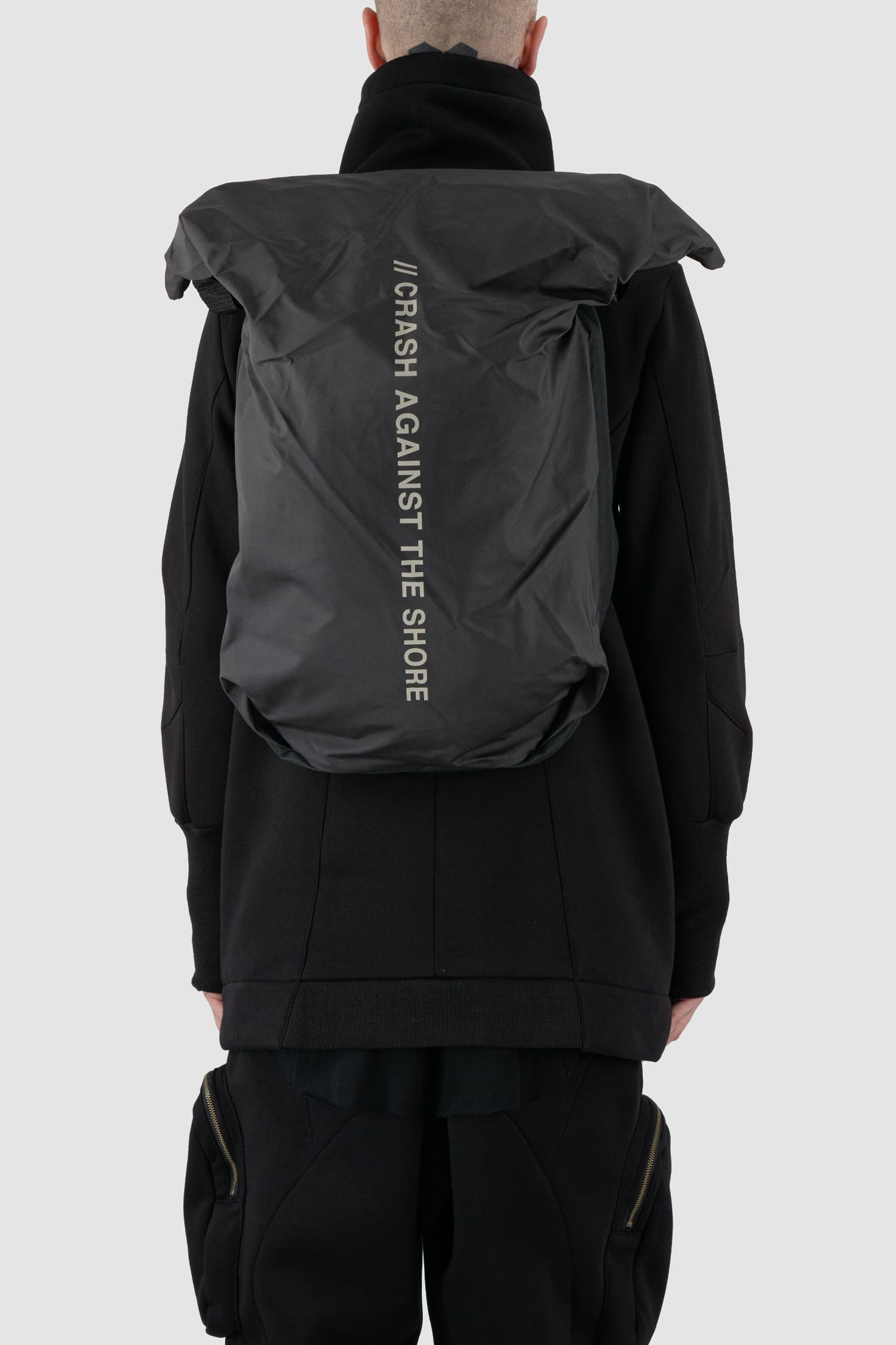 First Aid to the Injured - back view of black -Crash against the shore- utility backpack.