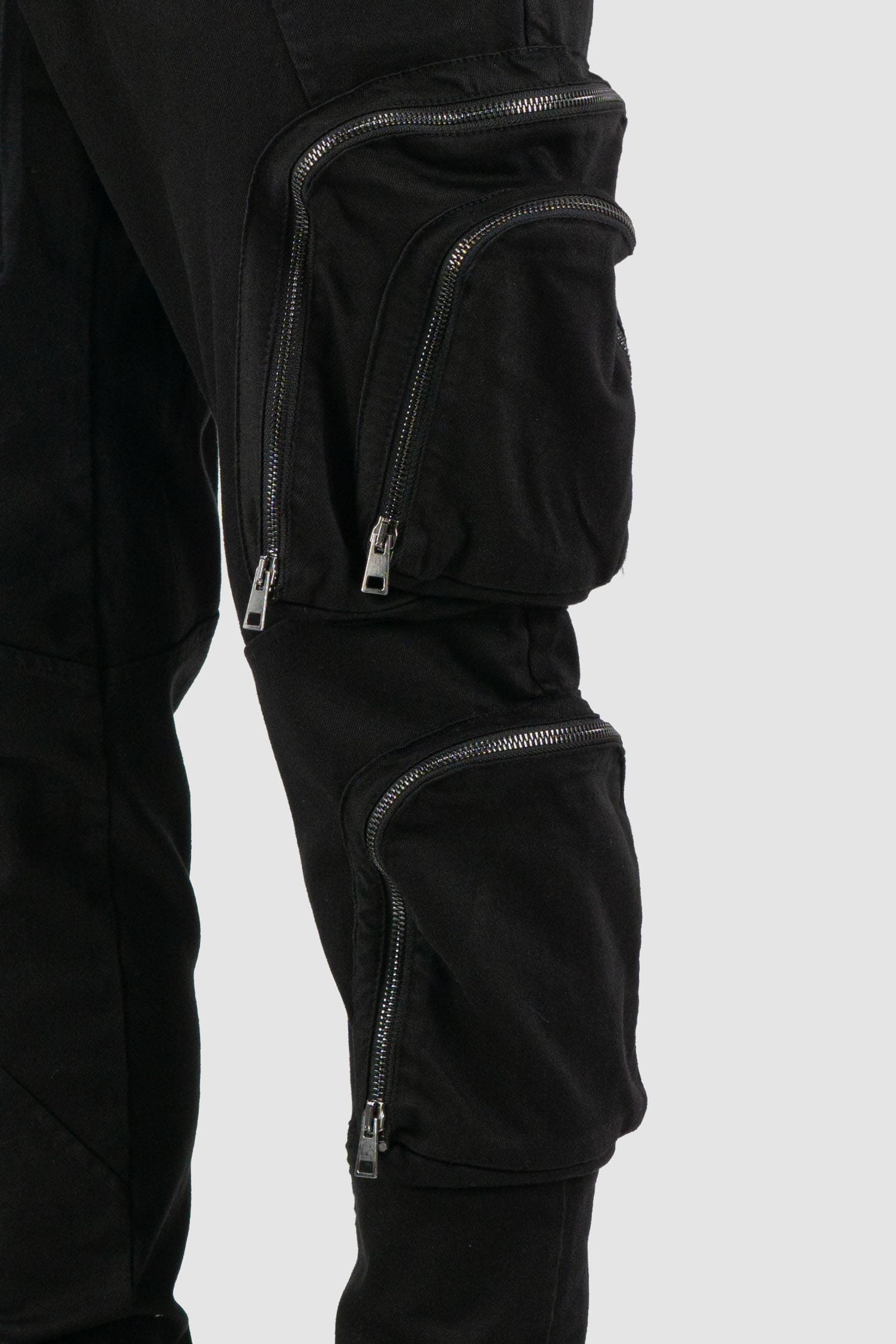 La Haine Inside Us - detail view of black cargo trousers with zipper for men from the FW24 collection made of warm dyed cotton.