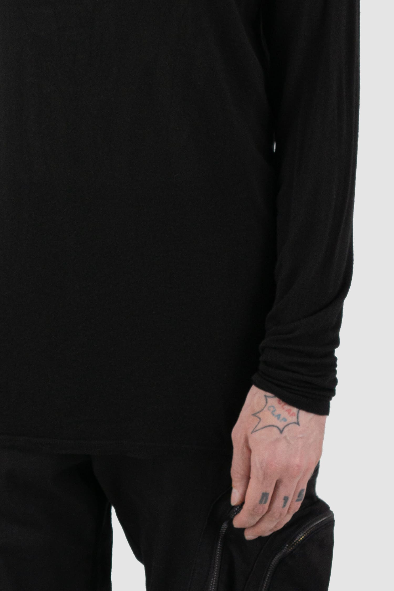 La Haine Inside Us - front detail view of black high neck wool and viscose blend sweater for men from the FW24 collection with extra long sleeves, center back seam and a light and soft touch.