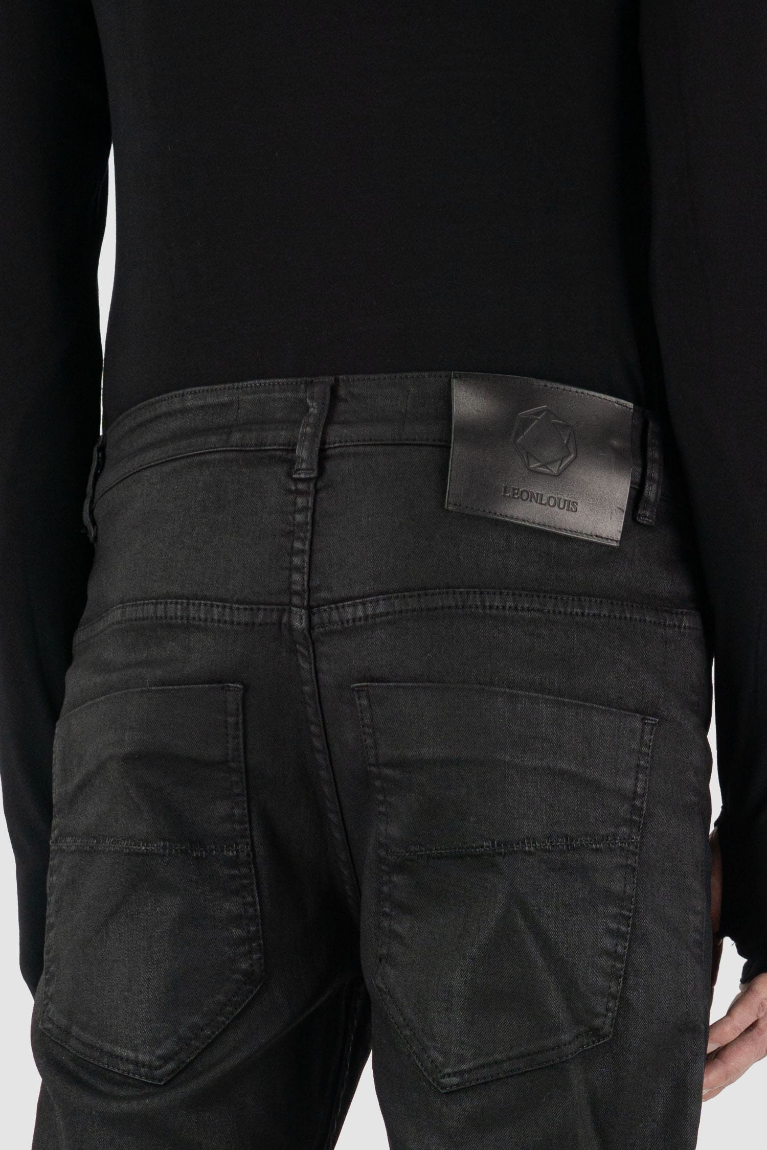 Leon Louis - label view of black waxed dart cut denim jeans, five pockets, slim fit, men's Permanent Collection.
