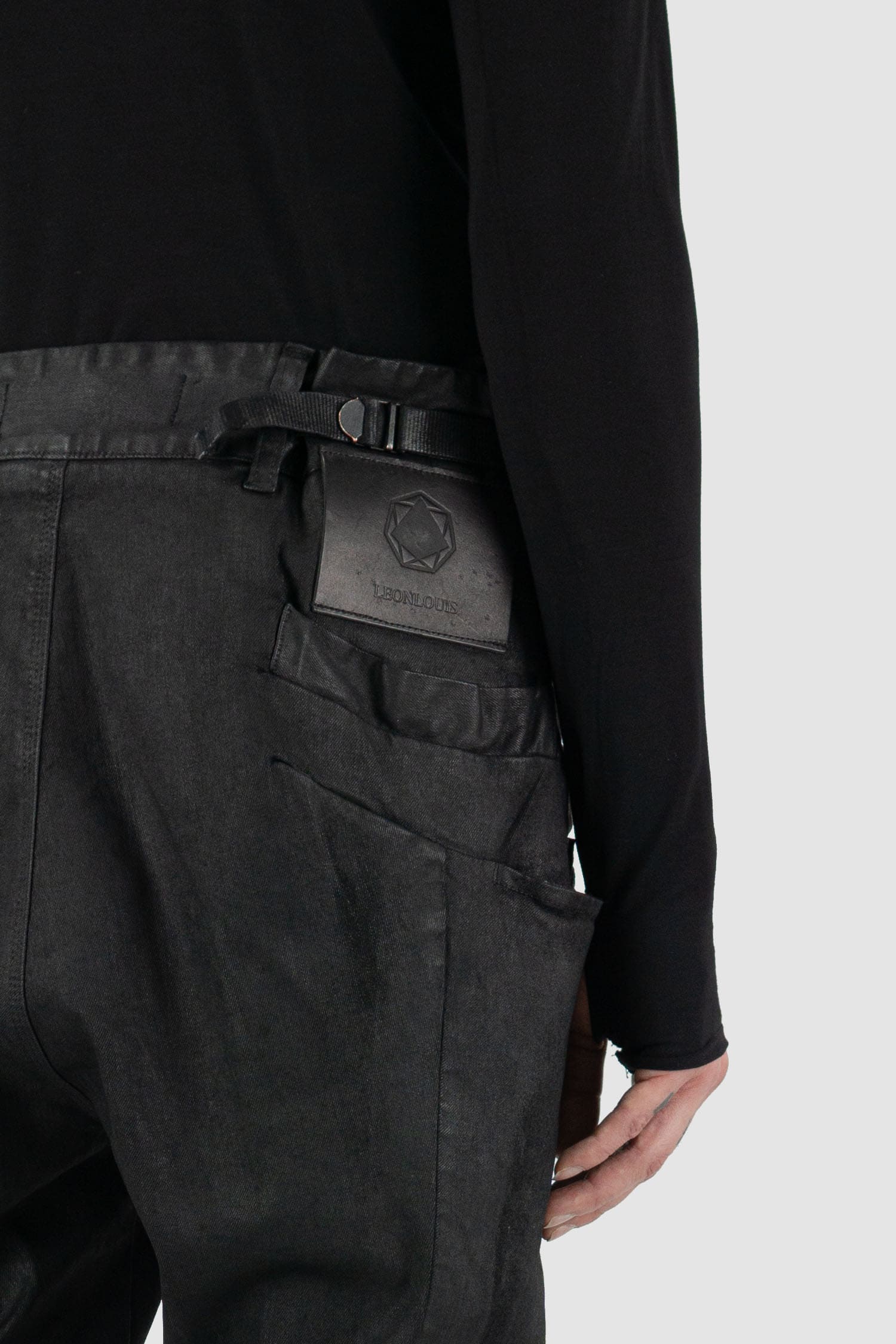 Leon Louis - label detail view of black waxed Xeon shaped line denim jeans, slim fit, men's Permanent Collection.