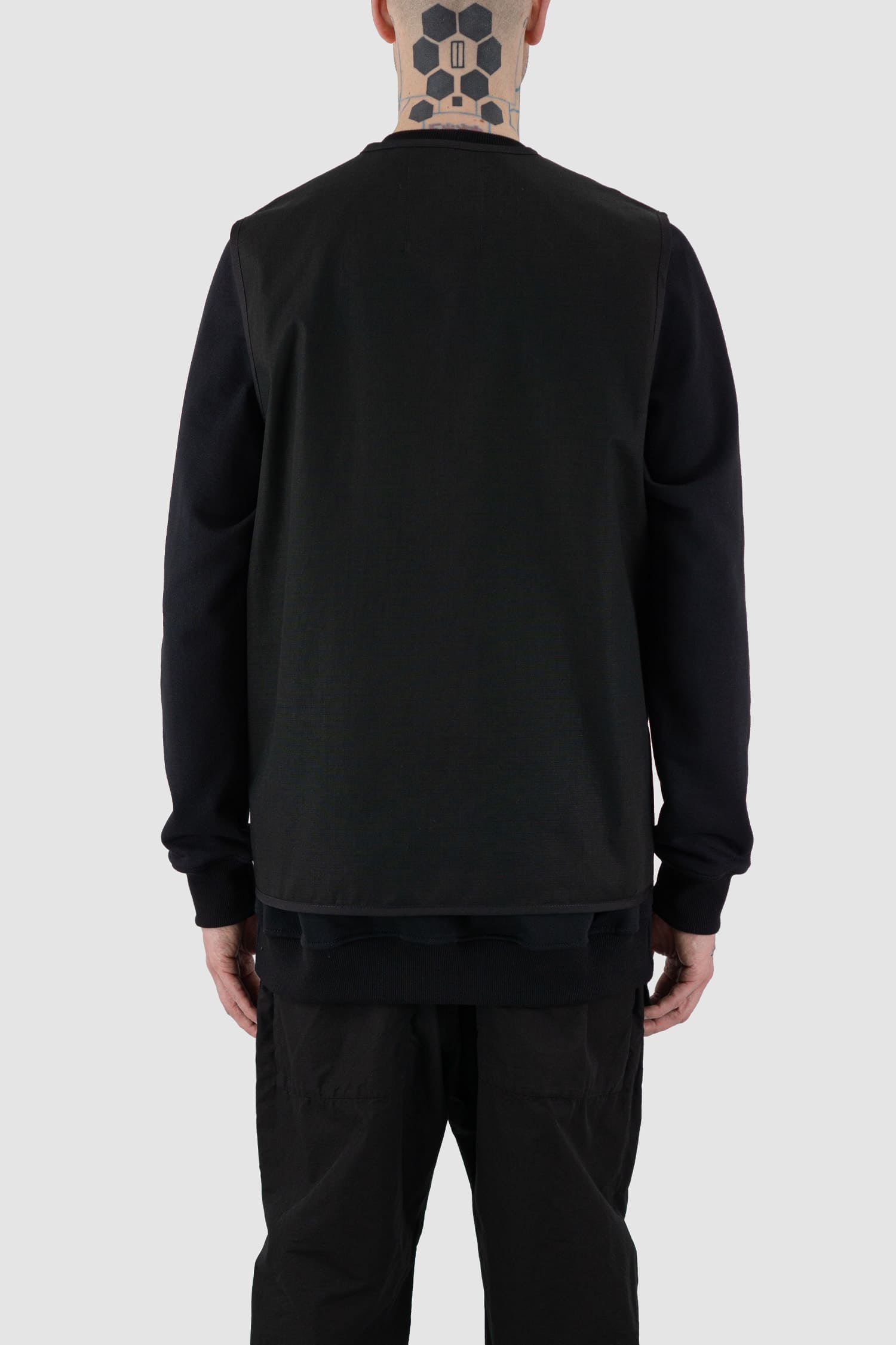 Nomen Nescio - back view of black cotton field vest with multiple pockets, zip fastening, loose fit.