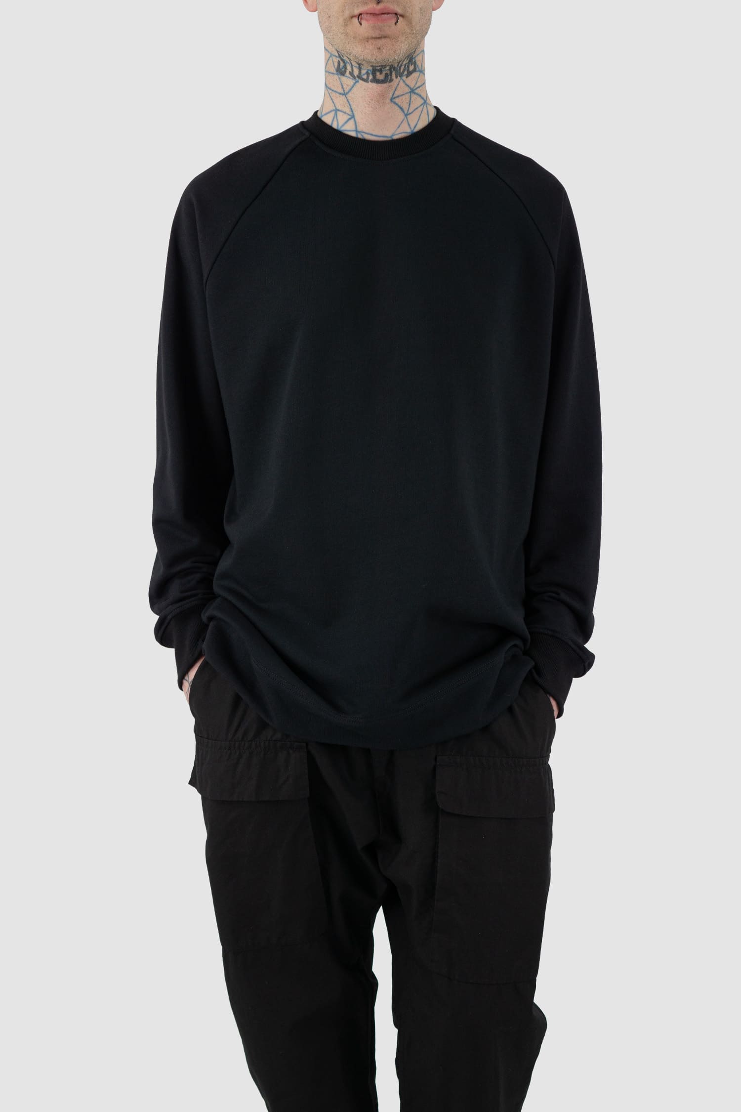 Nomen Nescio - Front legere view of black cotton raglan sweater with wool rib detail, spacious relaxed fit.