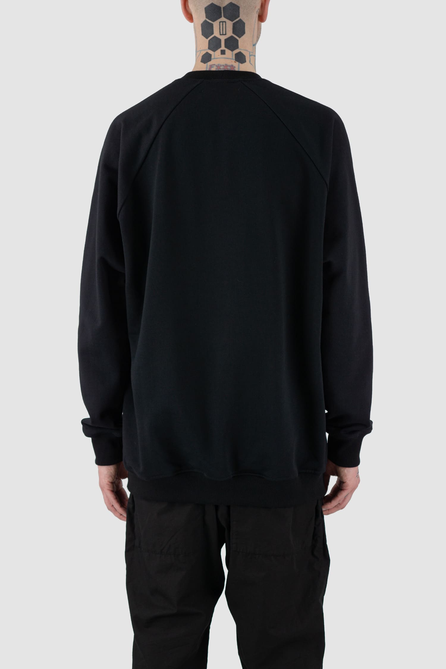 Nomen Nescio - back view of black cotton raglan sweater with wool rib detail, spacious relaxed fit.