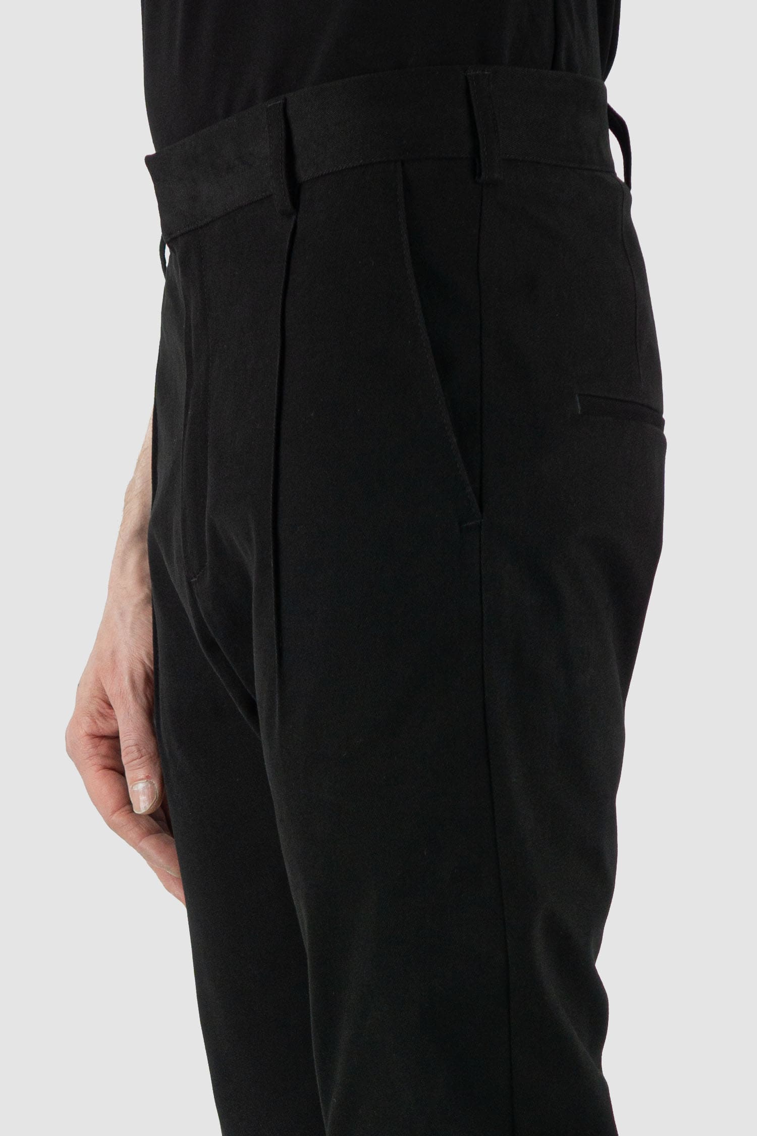 Nomen Nescio - pocket detail view of black cotton blend slim trousers with slanted front pockets, zip-fly fastening.