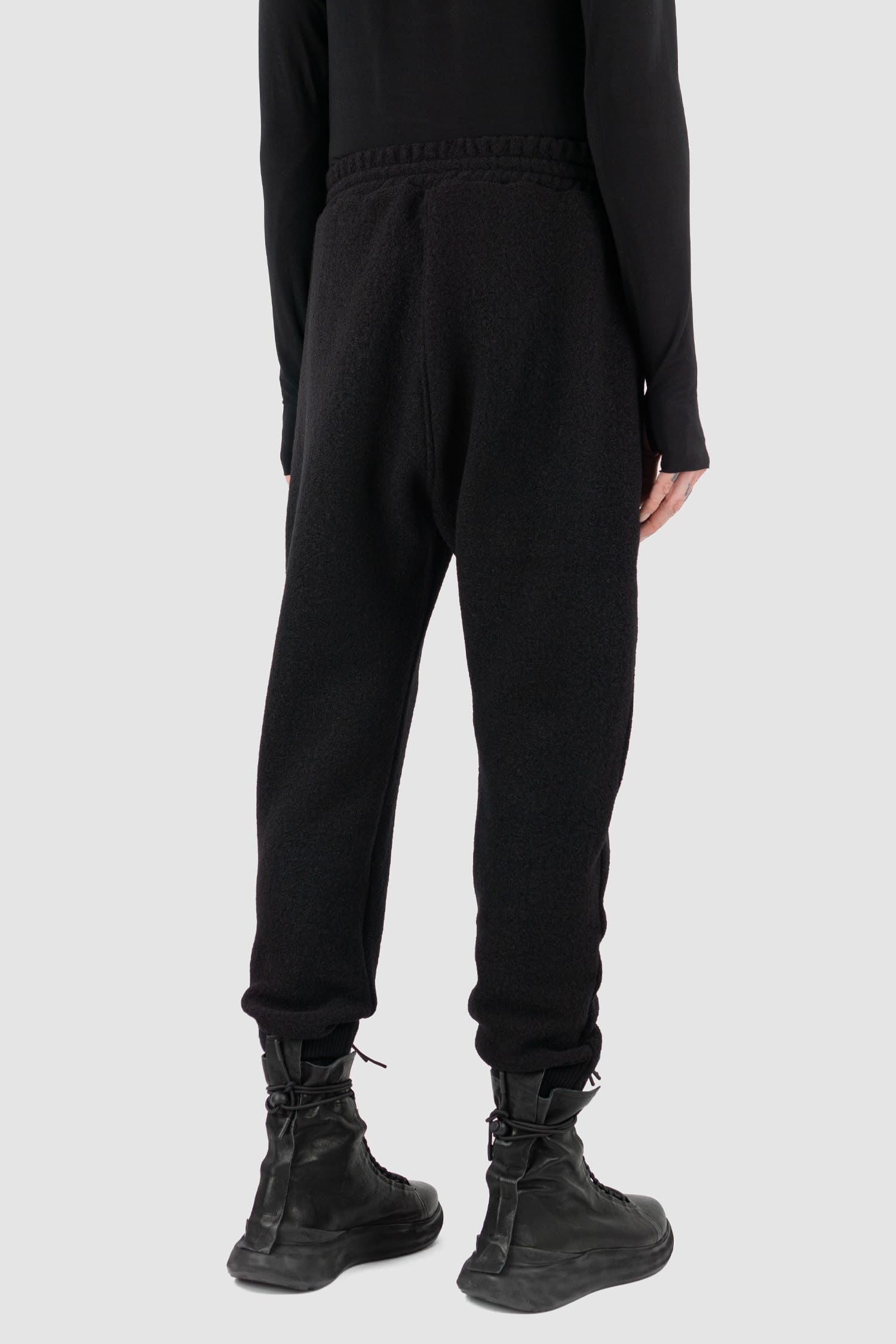 Nomen Nescio - back side view of black woolen sweatpants with elastic waistband, recycled wool, for men.