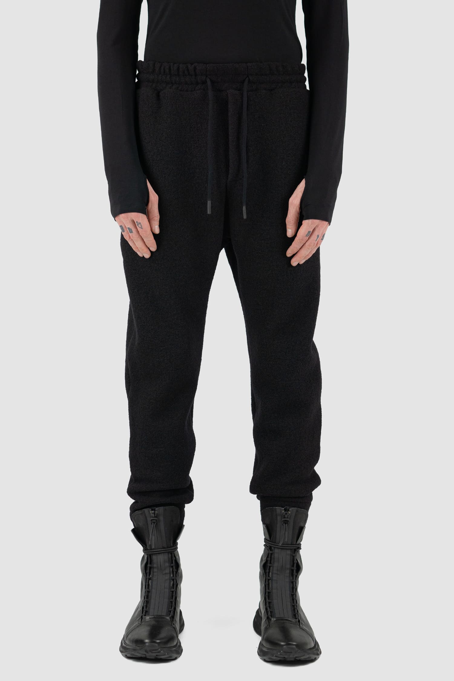 Nomen Nescio - Front view of black woolen sweatpants with elastic waistband, recycled wool, for men.