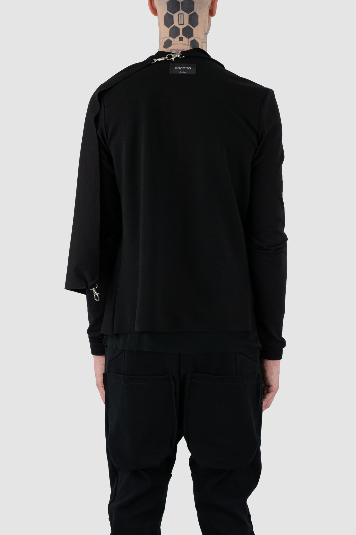 Obectra Studio - Back closed view of black clip cardigan with multiple clips for different styling options, slim fit, Permanent Collection.