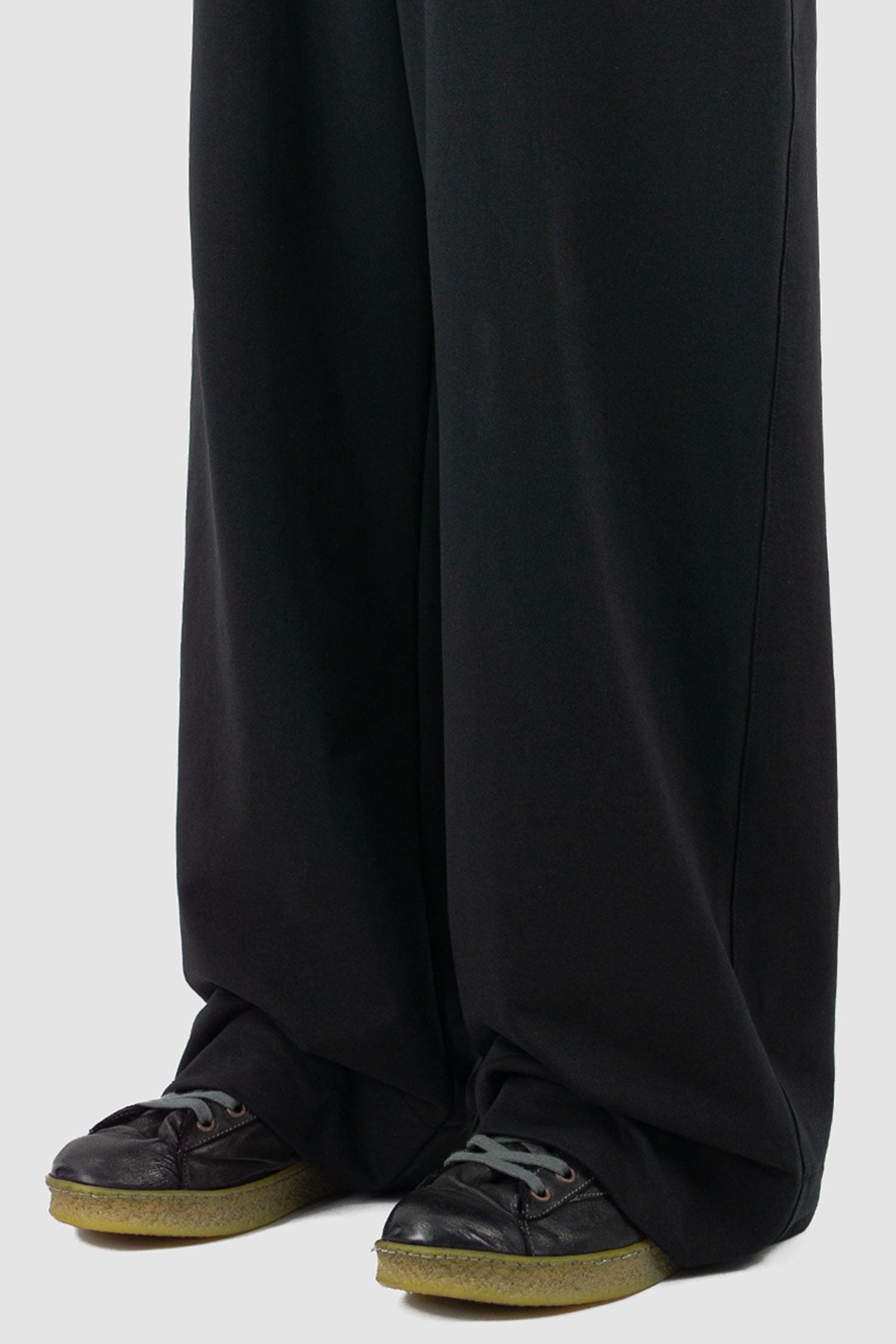 UY Studio - hem view of black cotton wide leg Gangster sweatpants with elastic waistband, clean edge hem, Permanent Collection.