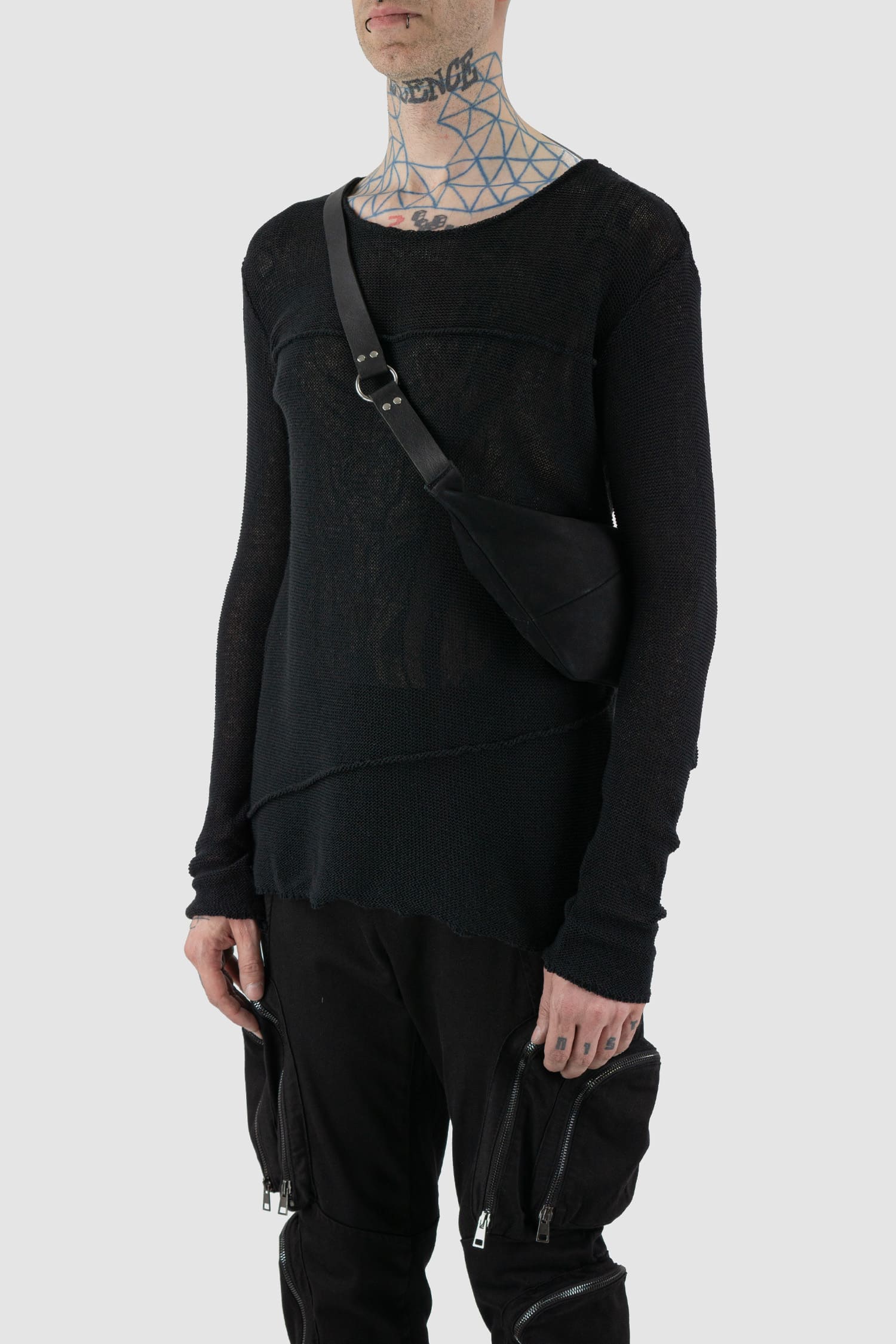 Werkschwarz - Model side view of black silky sanded nubuck leather fanny pack is a versatile accessory that can also be worn as a waist bag or crossbody bag. Part of the Permanent collection, it features a waxed finish, ventilation openings, and a metal ring for added functionality and style.
