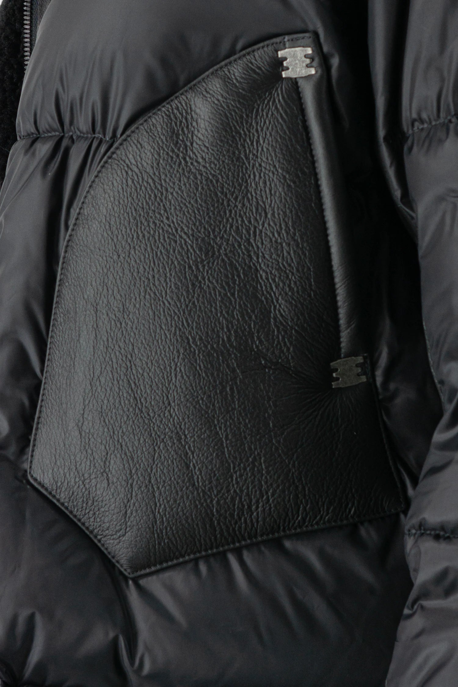 Isaac Sellam - pocket detail view of men’s Black Hooded Cropped Shearling and Down Puffer Jacket