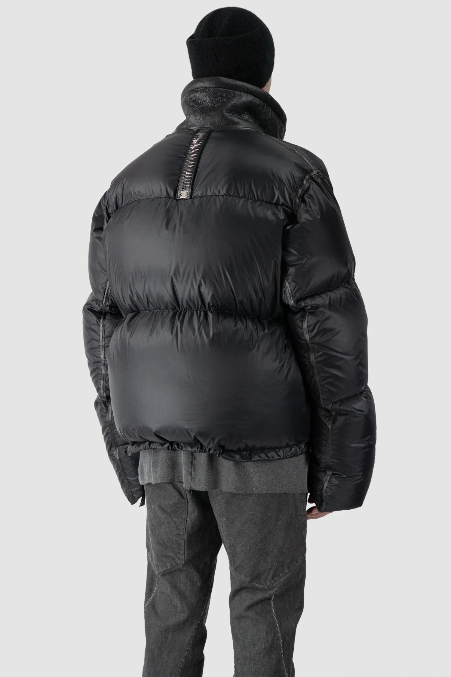 Isaac Sellam - model back side view of men’s Black Shearling Leather and Down Cropped Puffer Jacket