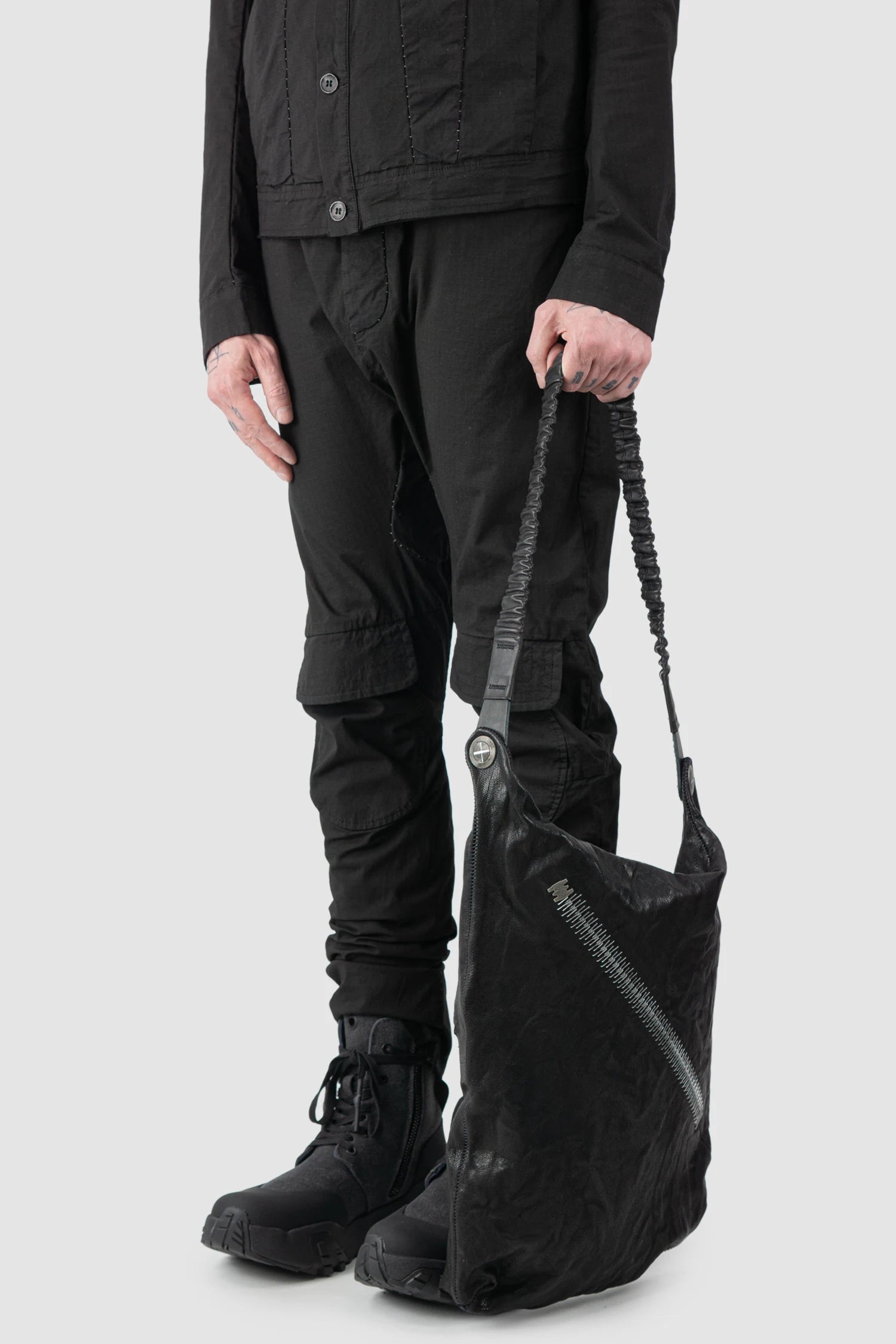 Isaac Sellam Experience - Nomade Men’s Black Asymmetric Lamb Leather Crossbody Bag model hand hold view