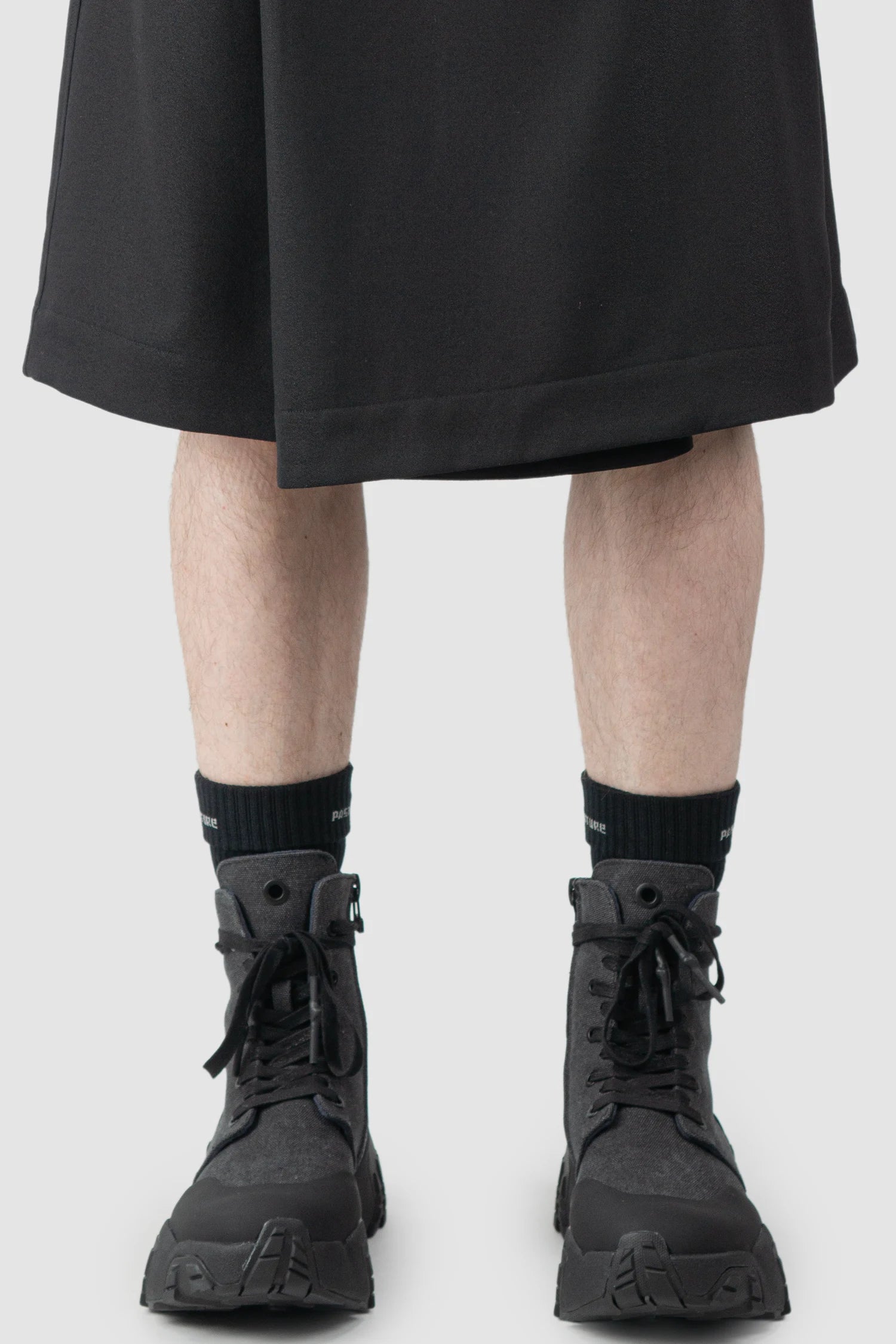 Joe Chia - Men’s Black Calf High Cotton Blend Logo Socks model front rolled view