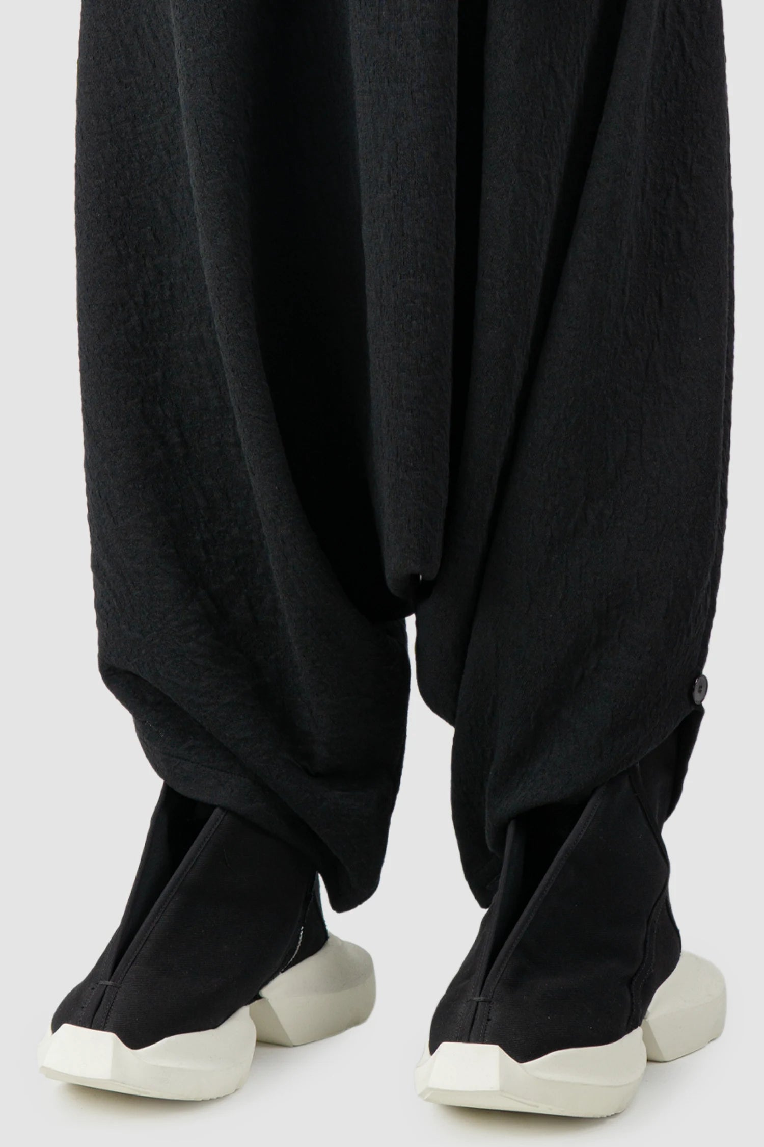 La Haine Inside Us - Men's Black Deep Crotch Cotton Trousers - hem detail view La Haine Inside Us - Men's Black Deep Crotch Cotton Trousers - hem detail view