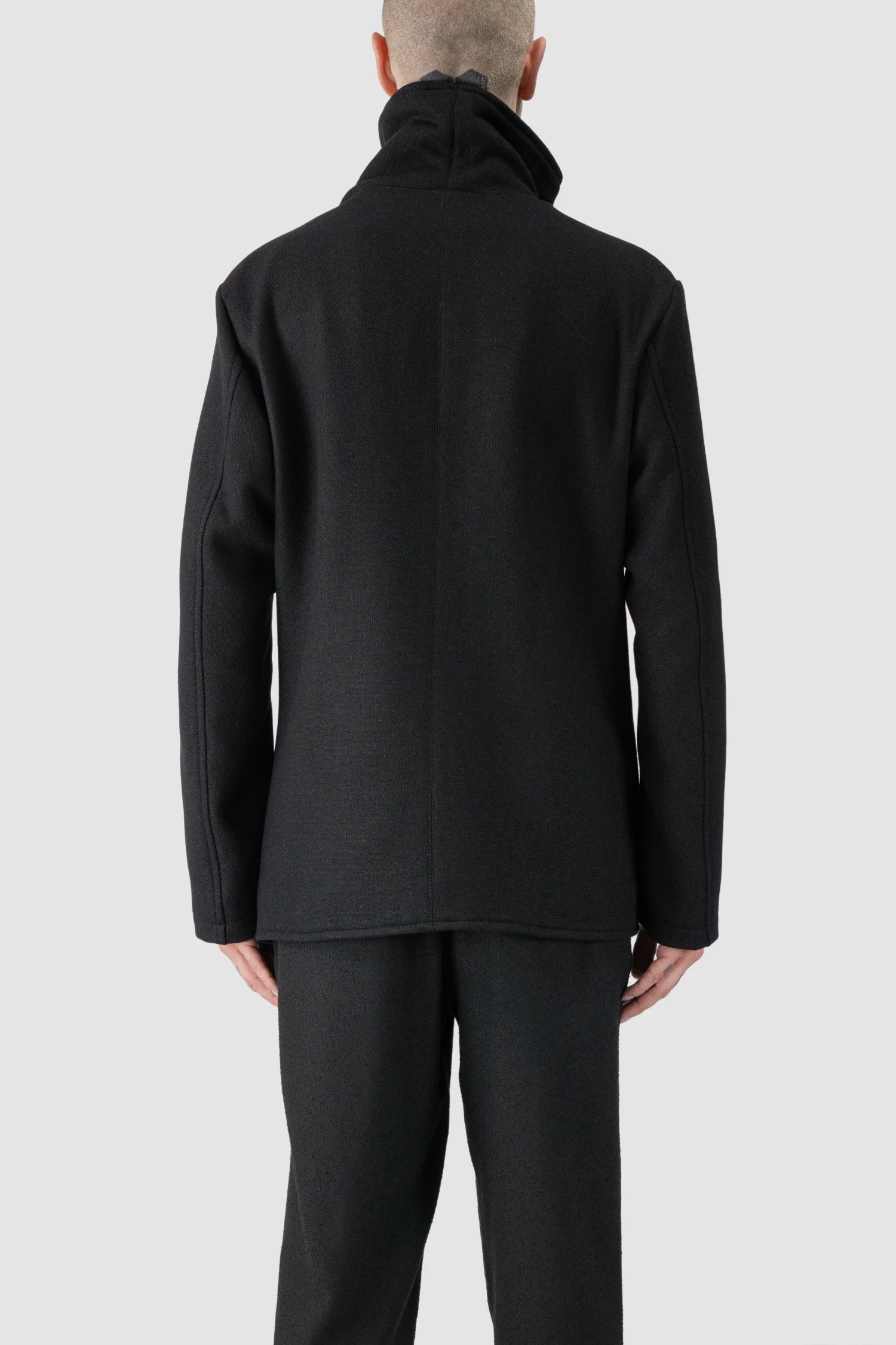 La Haine Inside Us - model back view of men’s FW25 Black Asymmetric Draped High Collar Wool Jacket