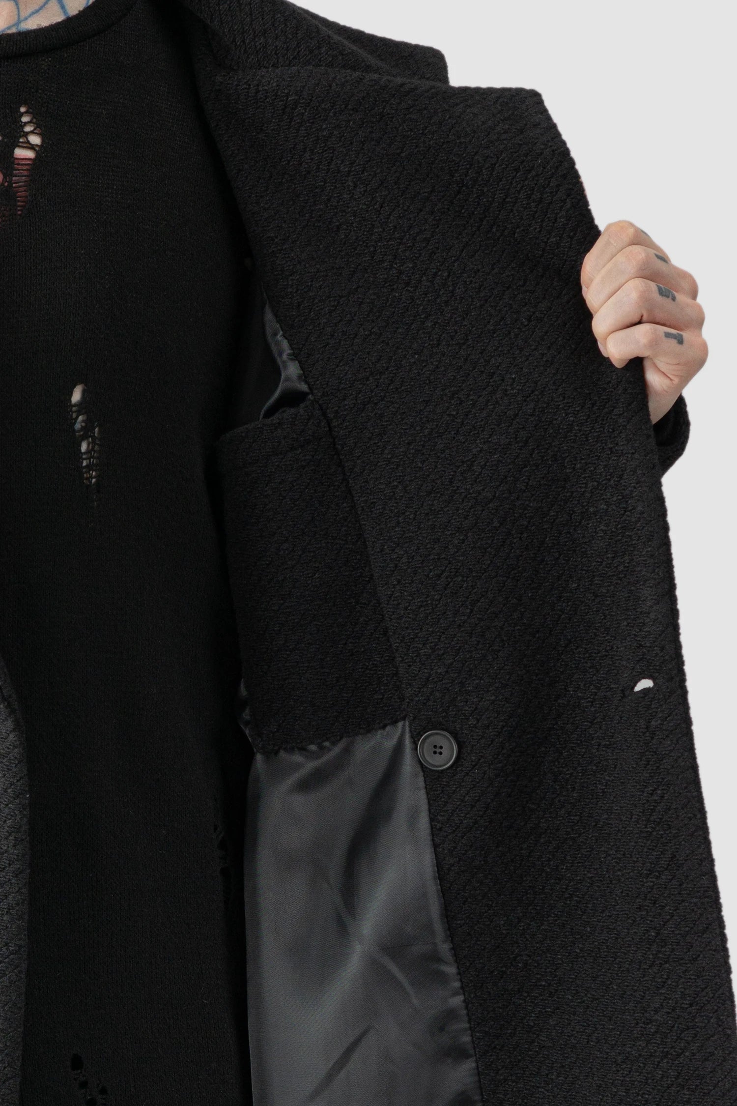 La Haine Inside Us - inner pocket detail view of men’s FW25 Black Long Wool Blend Coat with 2-Button Closure