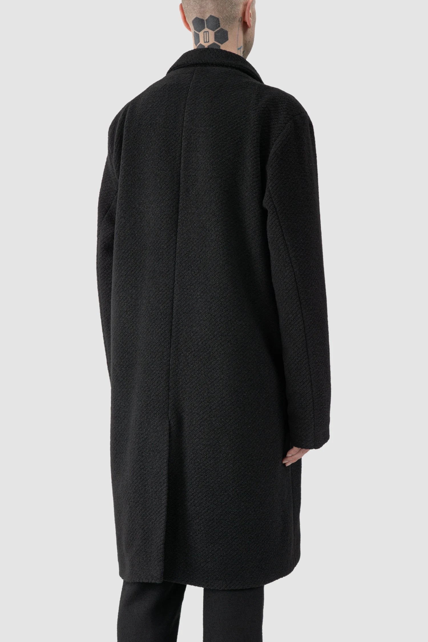 La Haine Inside Us - model back side view of men’s FW25 Black Long Wool Blend Coat with 2-Button Closure
