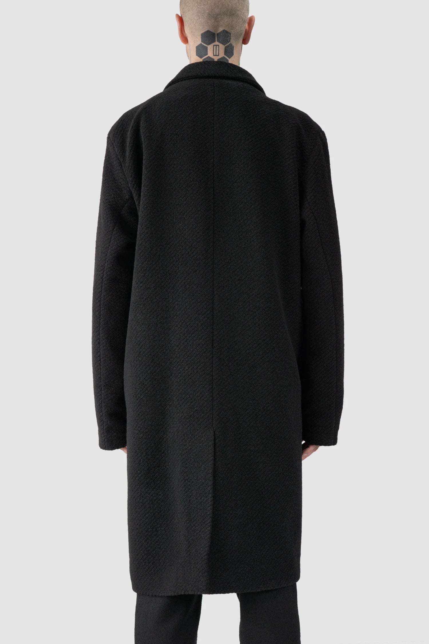 La Haine Inside Us - model back view of men’s FW25 Black Long Wool Blend Coat with 2-Button Closure