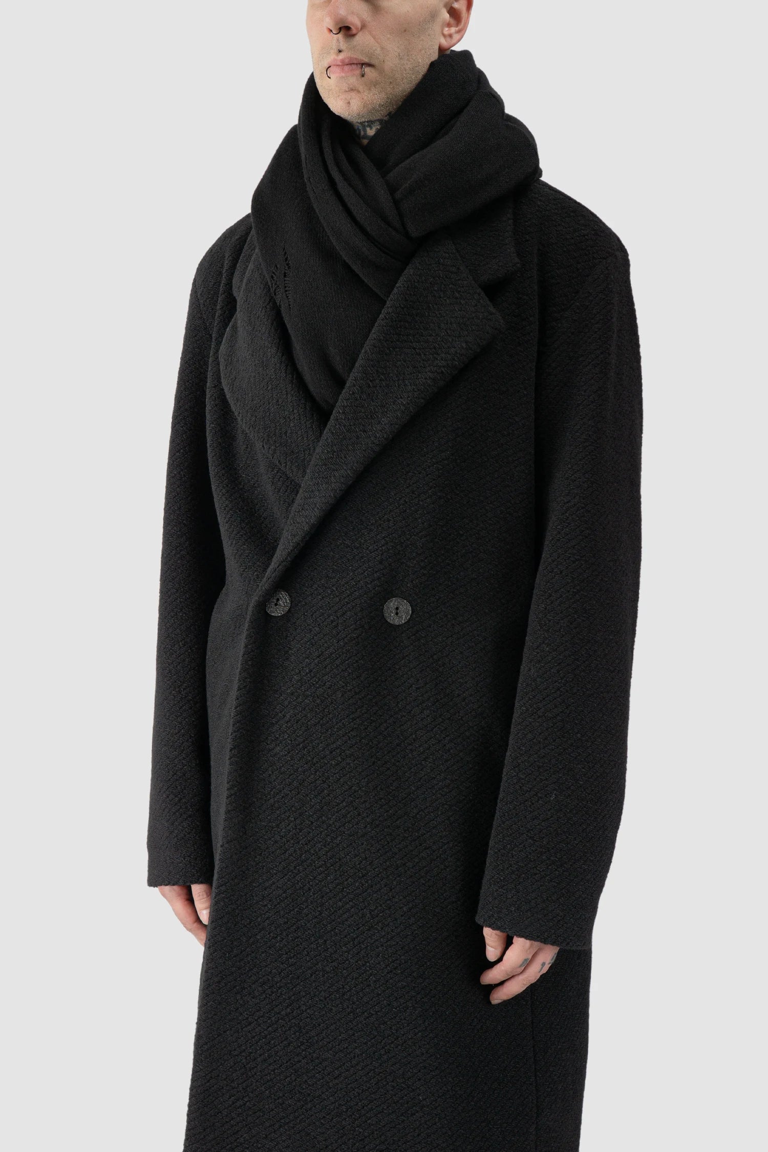 La Haine Inside Us - model side view of men’s FW25 Black Oversized Loop Viscose Blend Knit Scarf