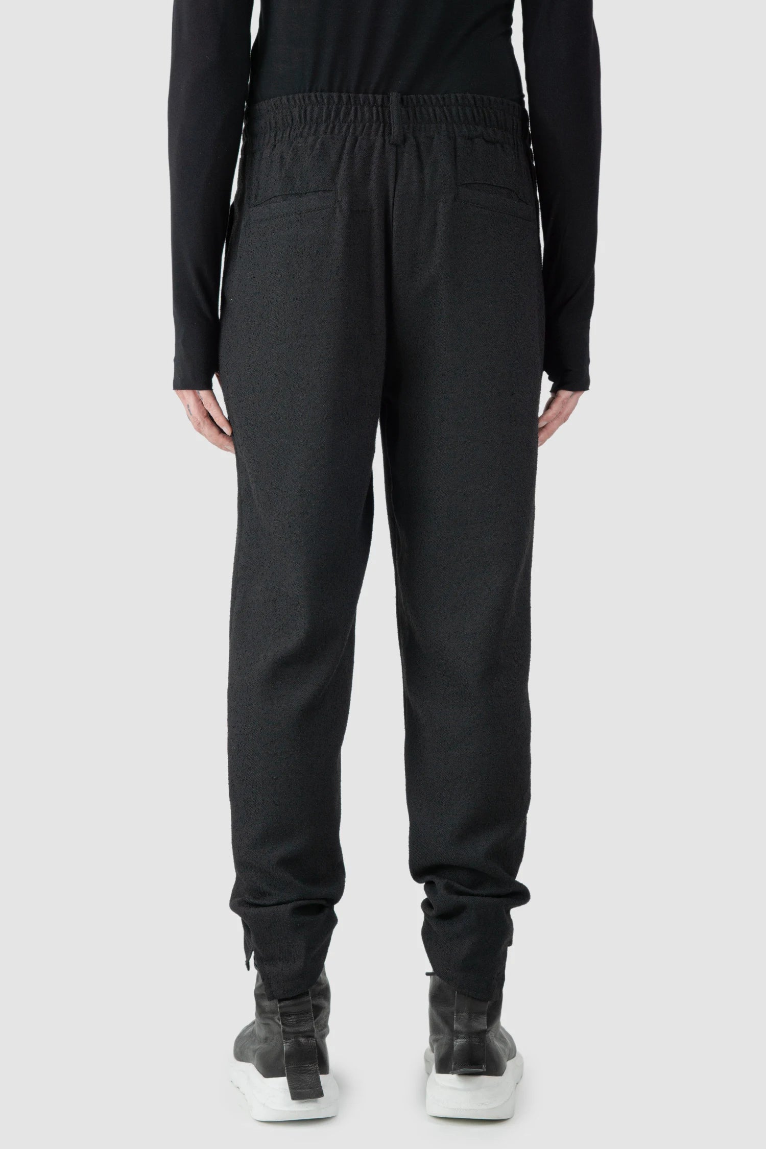 La Haine Inside Us - model back view of men’s FW25 Black Relaxed Soft Bouclé Trousers