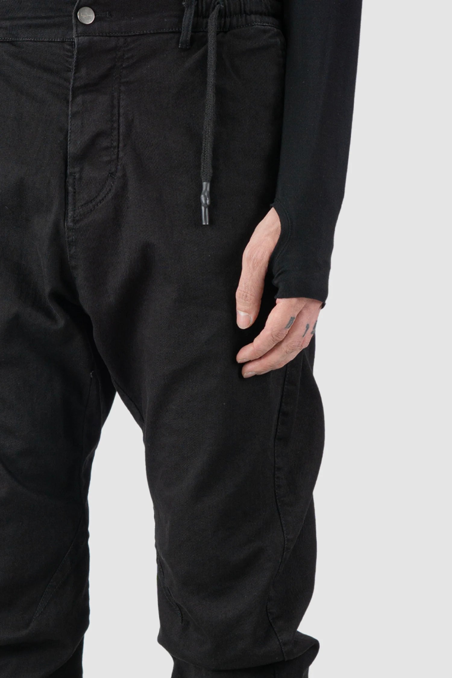 La Haine Inside Us - fabric detail view of men’s FW25 Black Twisted Leg Stretch Denim Jeans