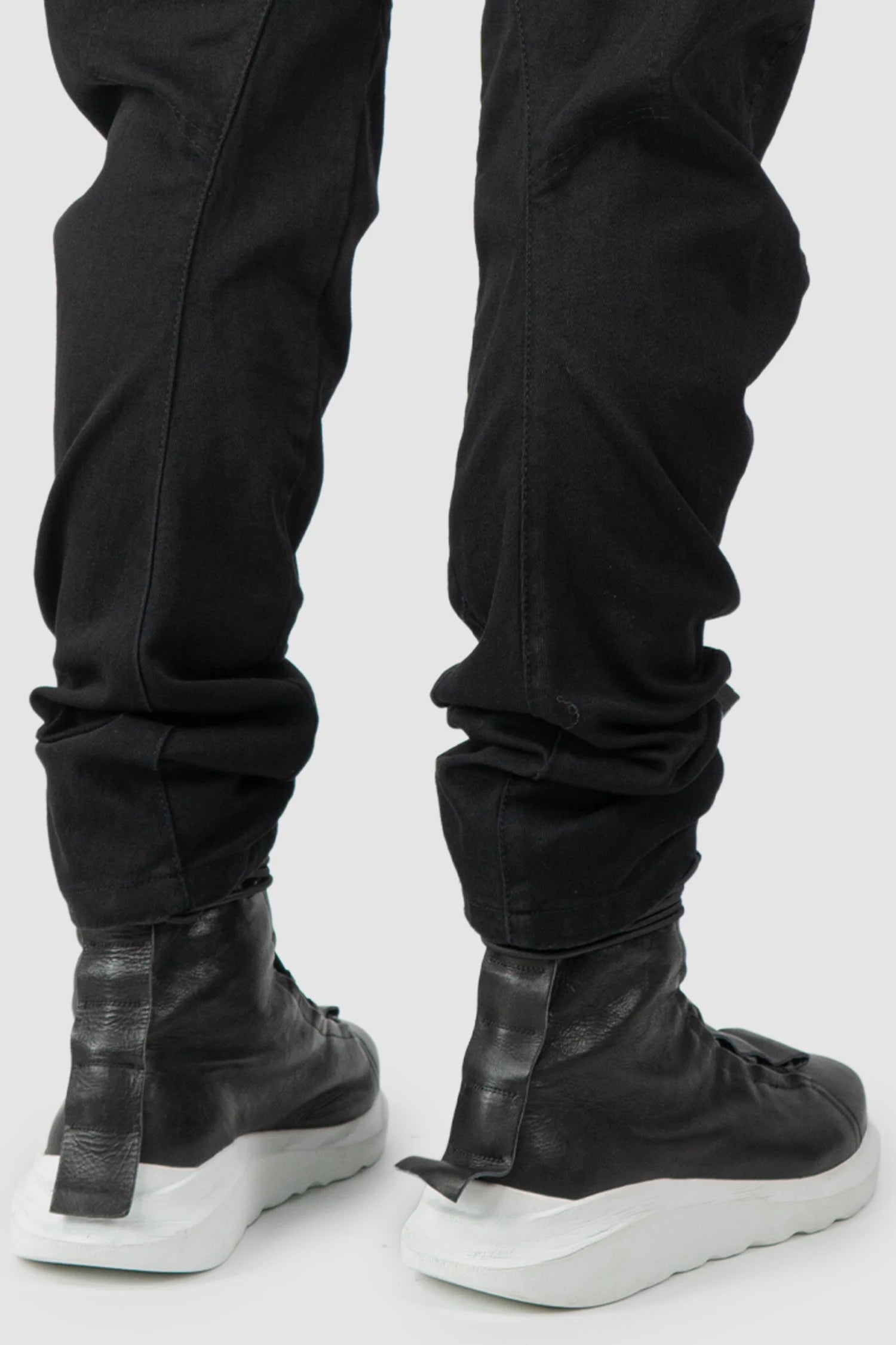 La Haine Inside Us - hem close up view of men’s FW25 Black Twisted Leg Stretch Denim Jeans