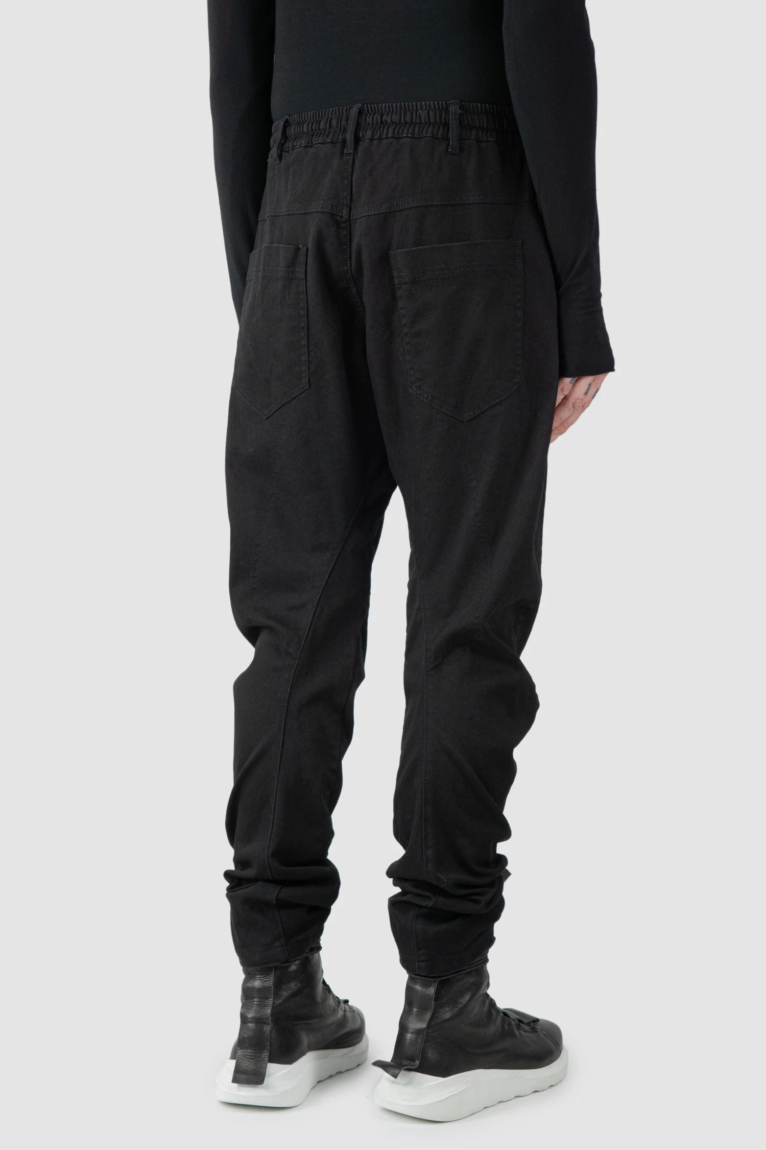 La Haine Inside Us - model back side view of men’s FW25 Black Twisted Leg Stretch Denim Jeans