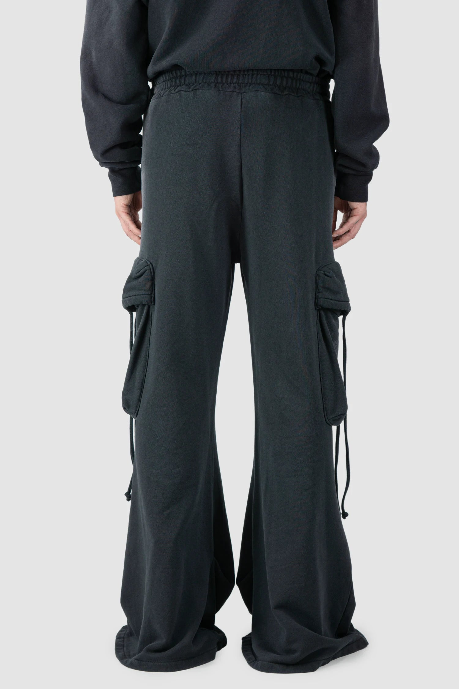 La Haine Inside Us - model back view of men’s FW25 Grey Sprayed Cotton Wide Leg Cargo Jogger Pants