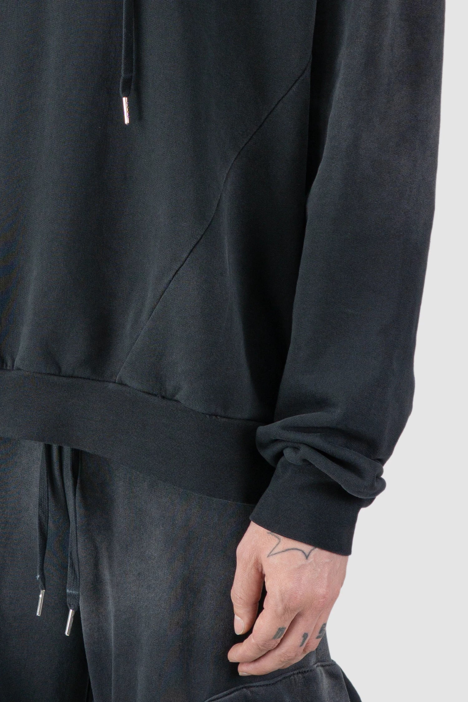 La Haine Inside Us - hem detail view of men’s FW25 Grey Sprayed Degrade Cotton Hooded Sweater