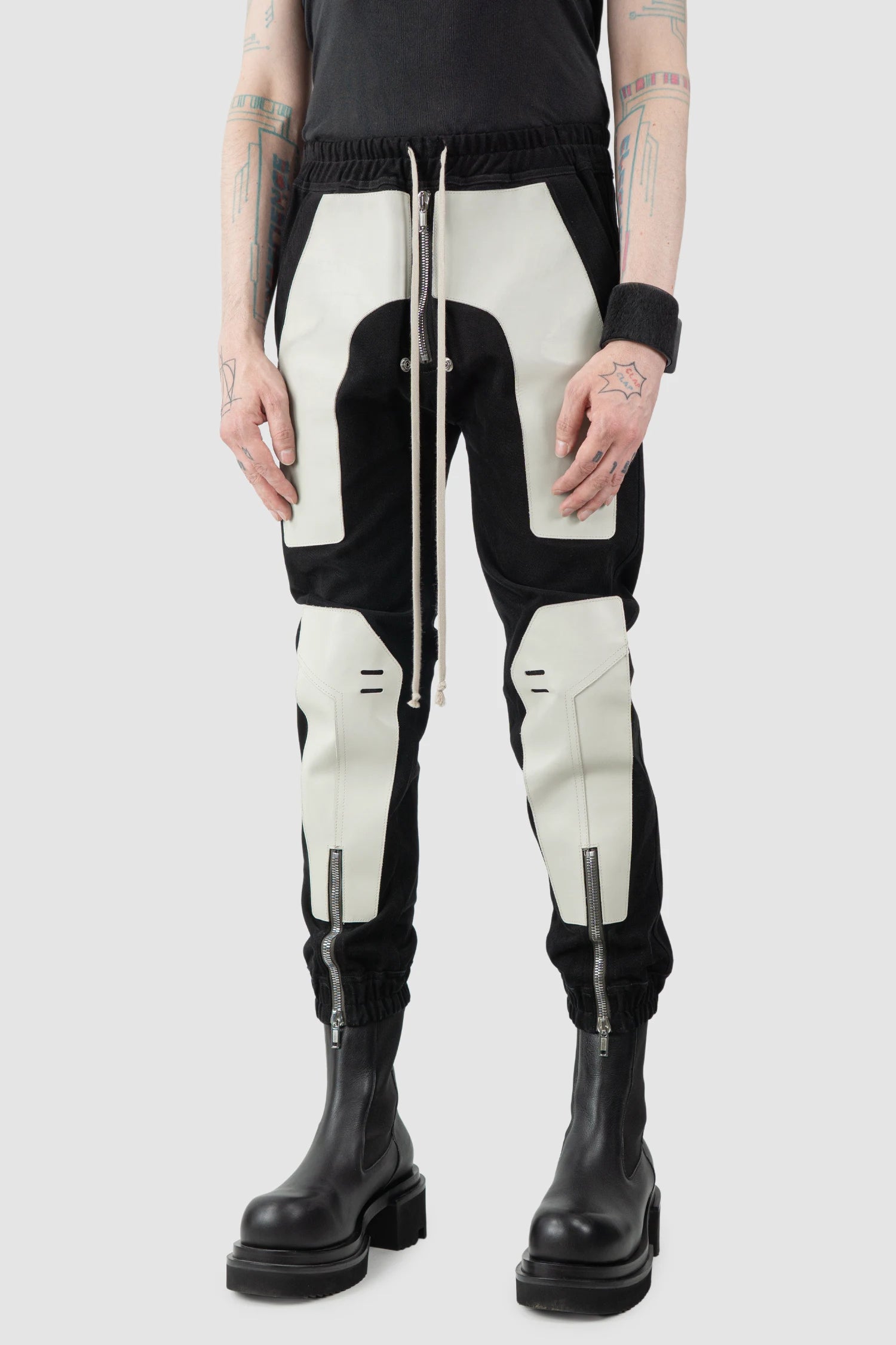 Rick Owens - Black Leather Patch Larry Cargo Joggers FW22 "Strobe" - model front side view Rick Owens - Black Leather Patch Larry Cargo Joggers FW22 "Strobe" - model front side view