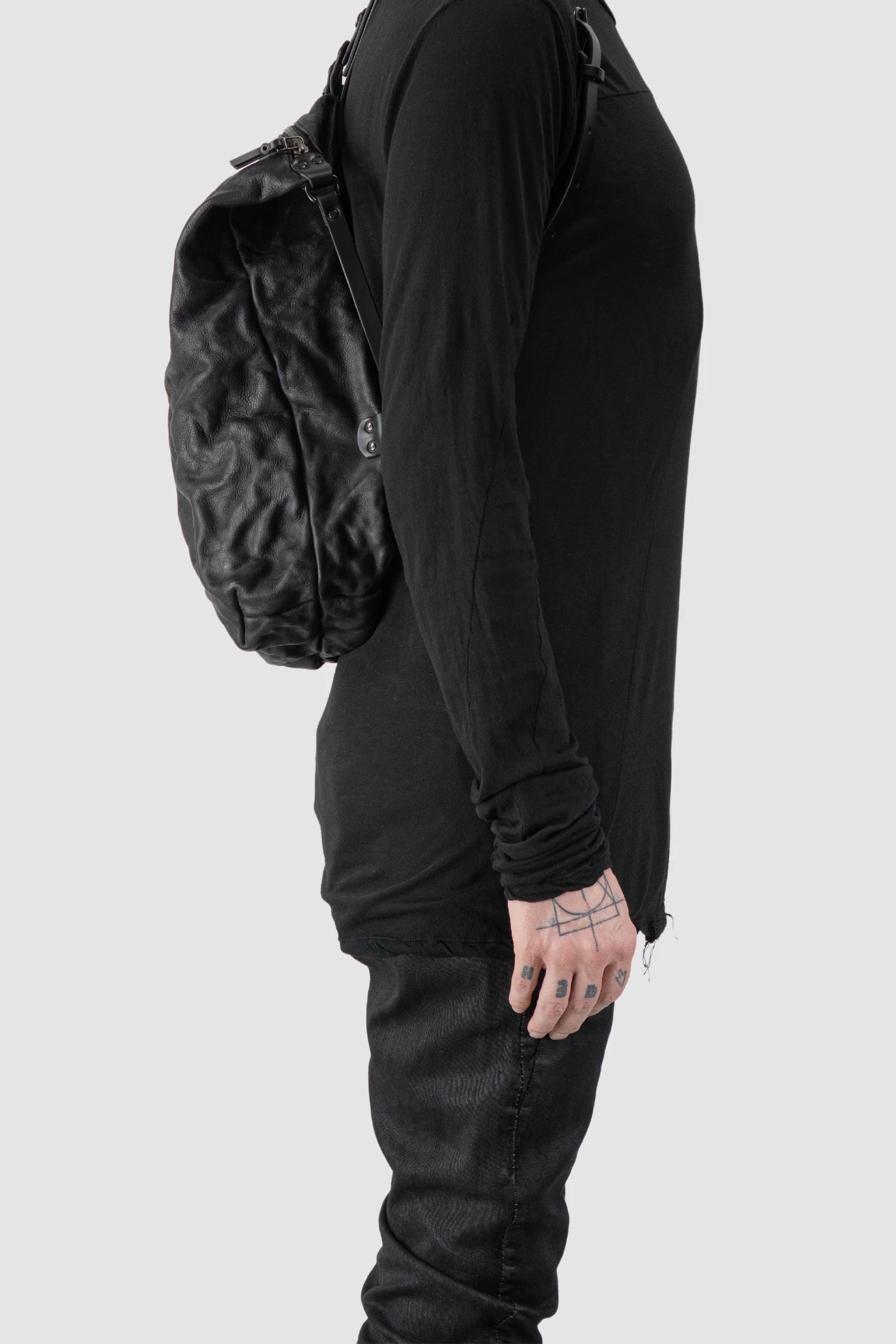 TEO NG - NIKS - model right view of men’s Black Crinkled Leather Backpack
