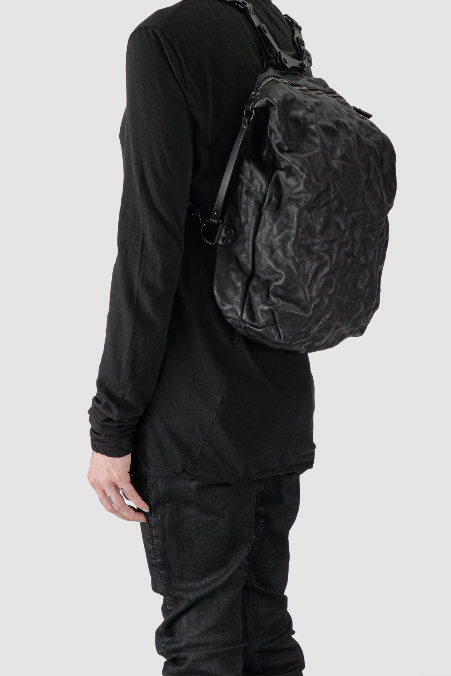 TEO NG - NIKS - model left front view of men’s Black Crinkled Leather Backpack