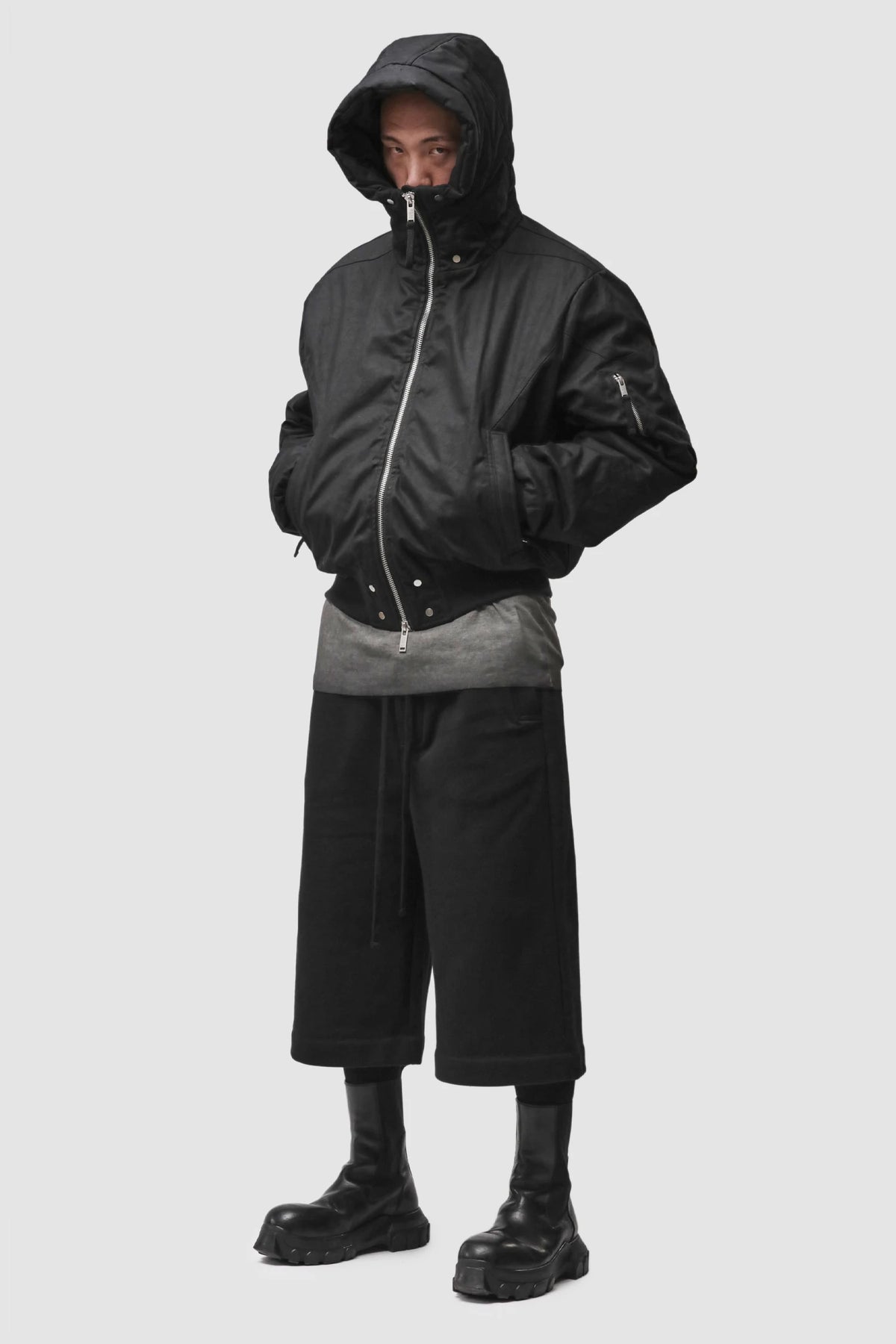 Thom Krom - Men’s Black Hooded Cotton Bomber Jacket M-J-89 model full side view Thom Krom - Men’s Black Hooded Cotton Bomber Jacket M-J-89 model full side view