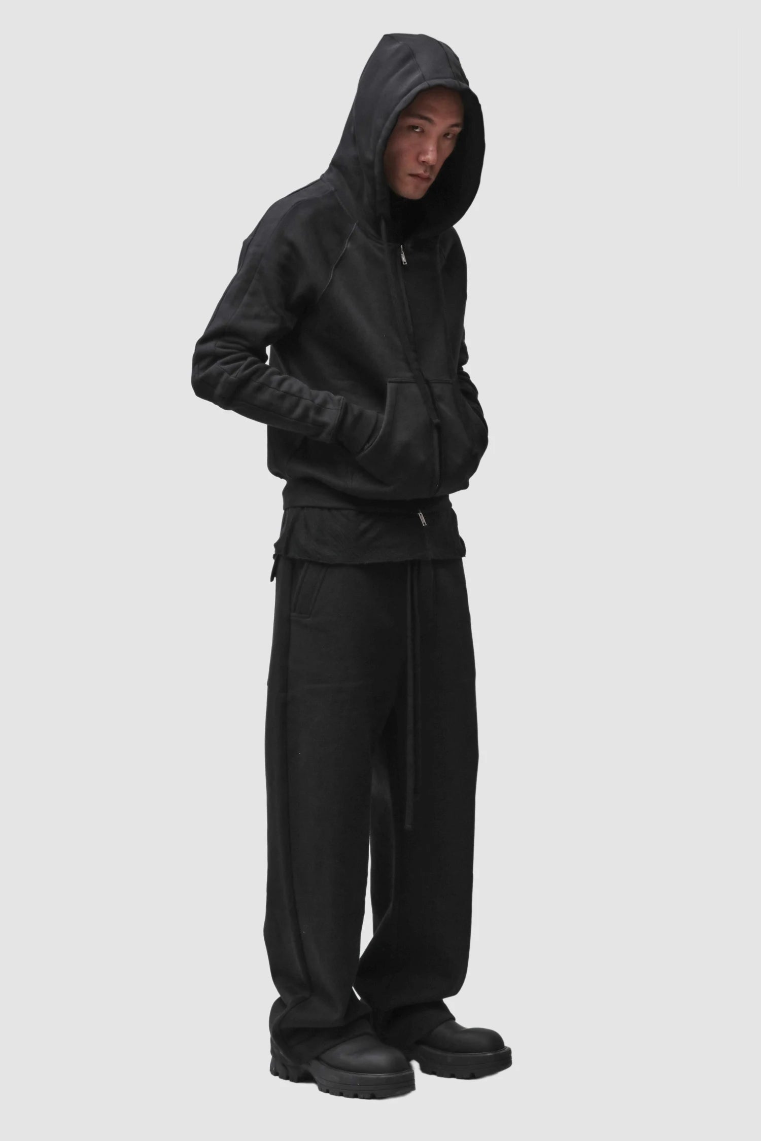 Thom Krom - Men’s Black Hooded Cotton Zip Sweater M-SJ-711 model full side view Thom Krom - Men’s Black Hooded Cotton Zip Sweater M-SJ-711 model full side view