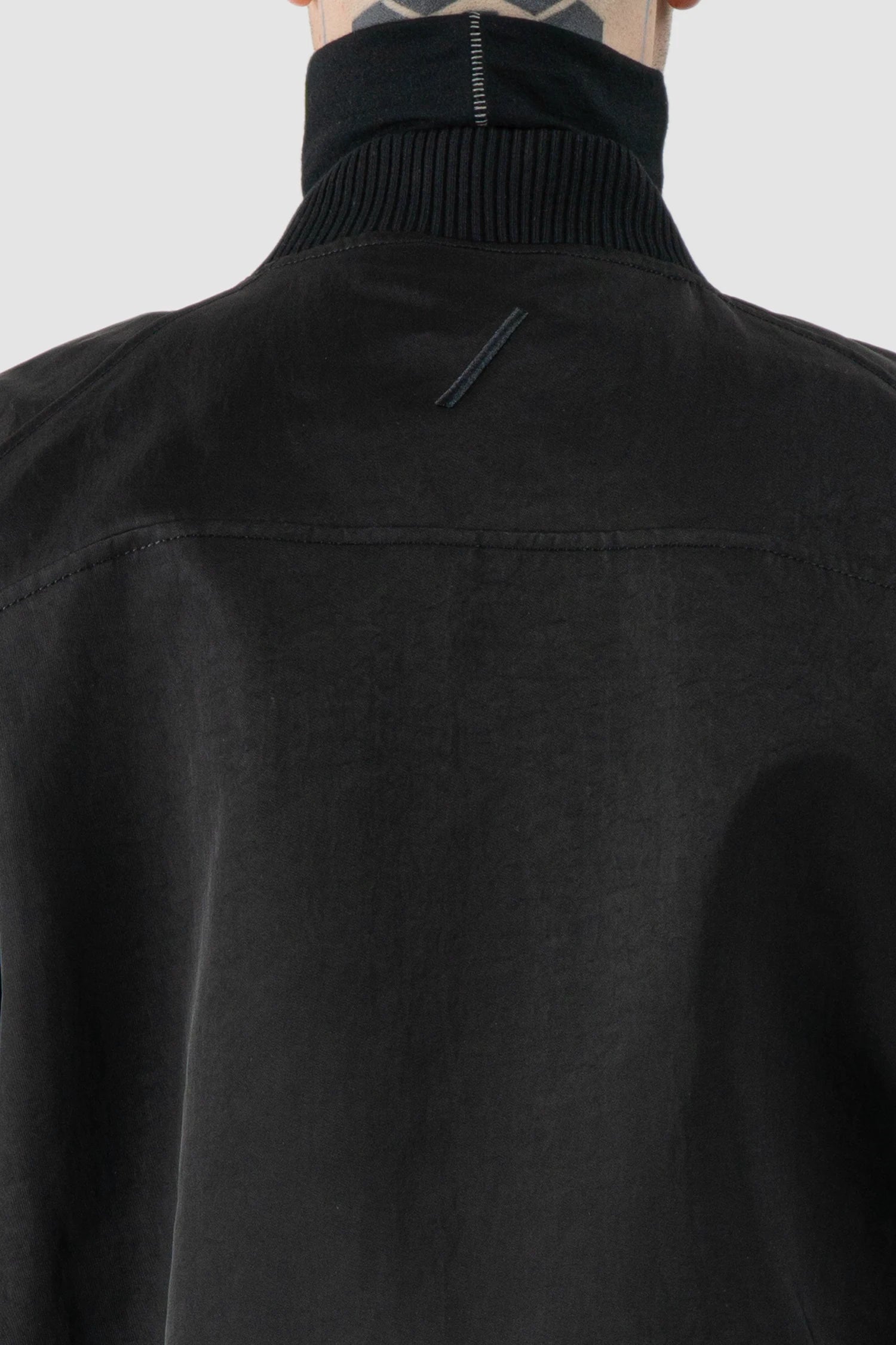 Thom Krom – Men's Black Recycled Tech Bomber Jacket - logo detail view Thom Krom – Men's Black Recycled Tech Bomber Jacket - logo detail view