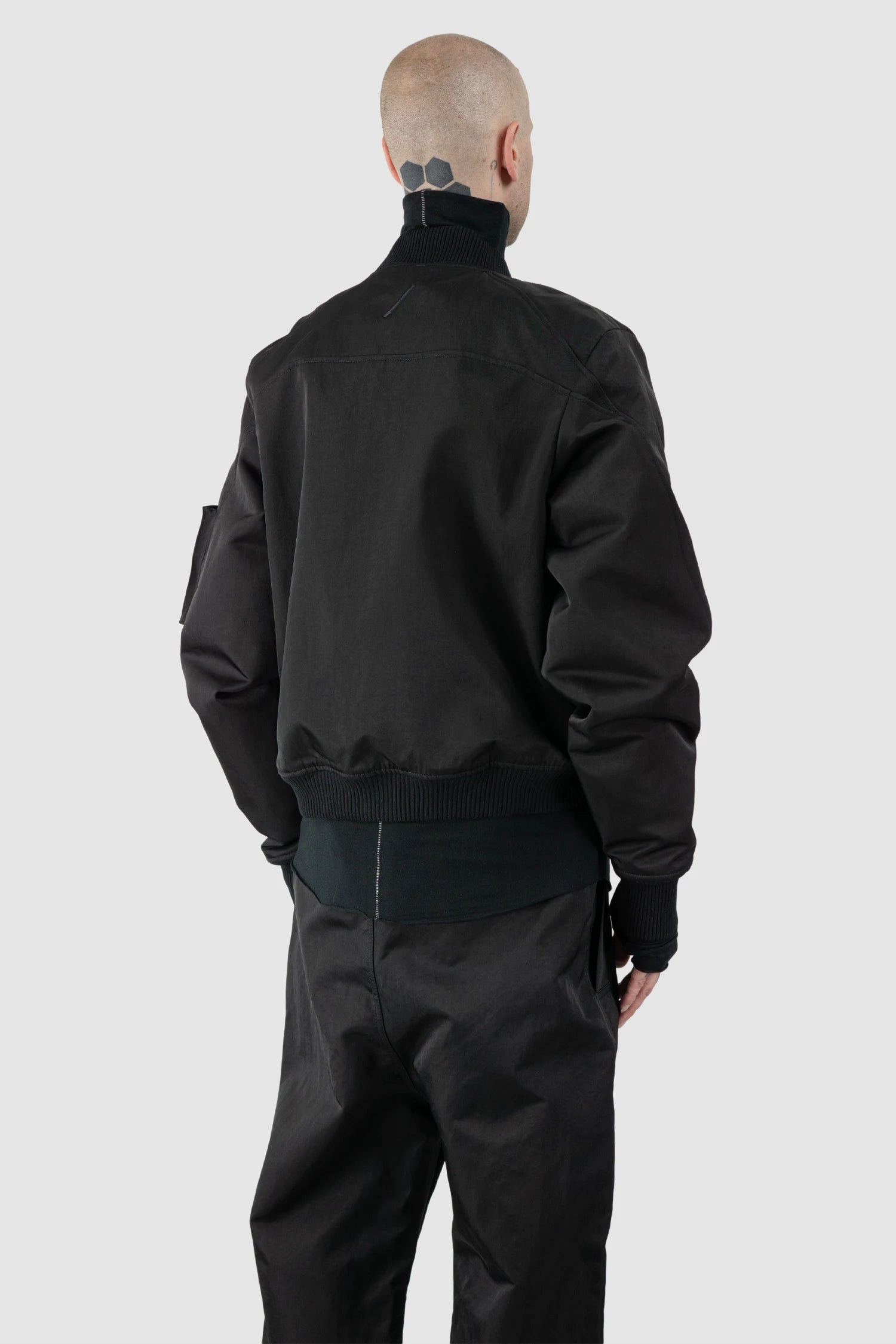 Thom Krom – Men's Black Recycled Tech Bomber Jacket - model back side view Thom Krom – Men's Black Recycled Tech Bomber Jacket - model back side view