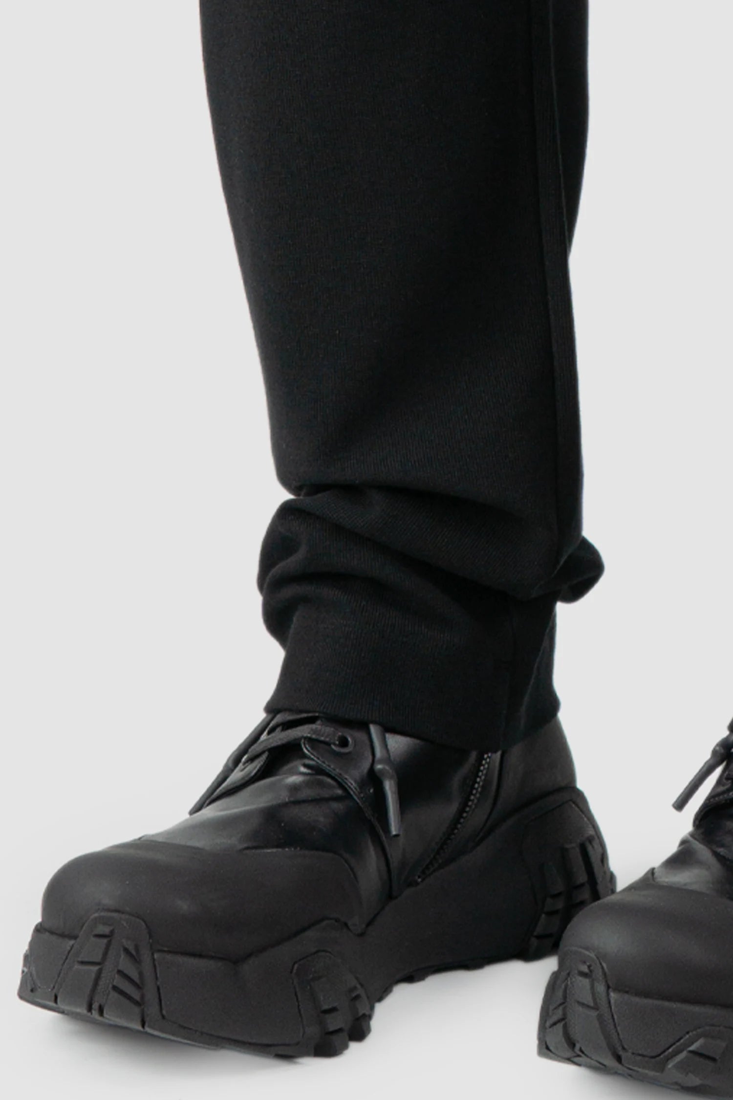 Thom Krom - model front hem view of black Loose Fit Straight Leg Cotton Trousers - M-ST-503