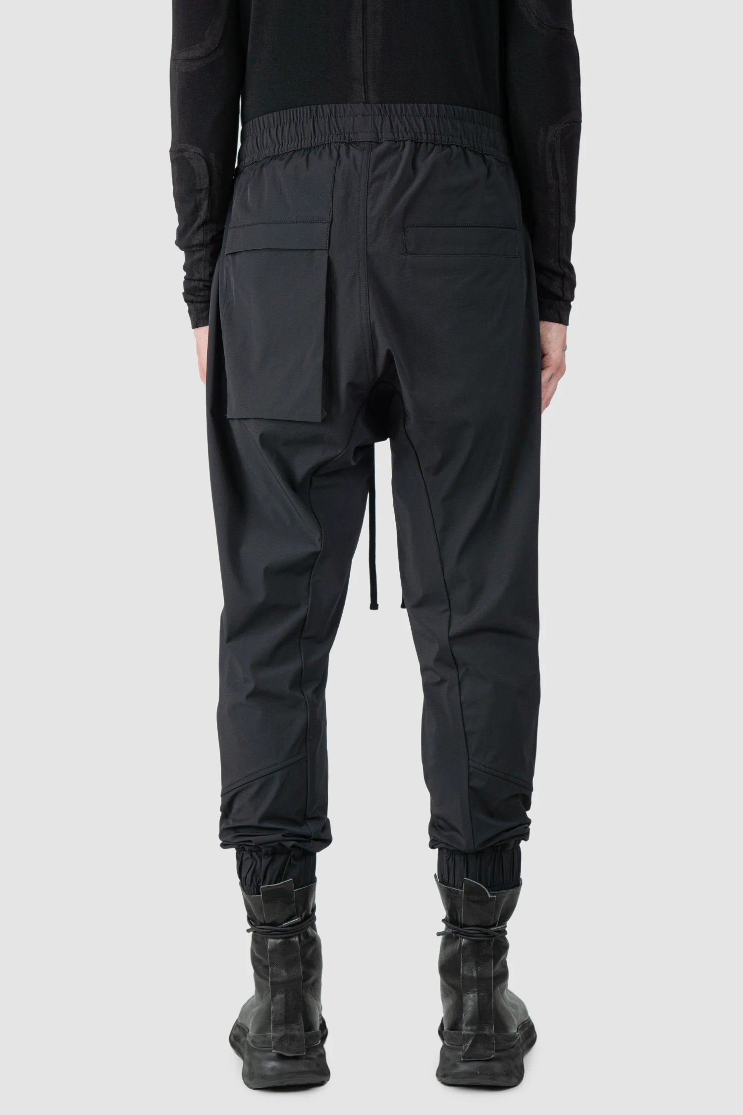 Thom Krom - model back view of men’s FW25 Black Front Pocket Woven Stretch Cargo Trousers - M-P-27