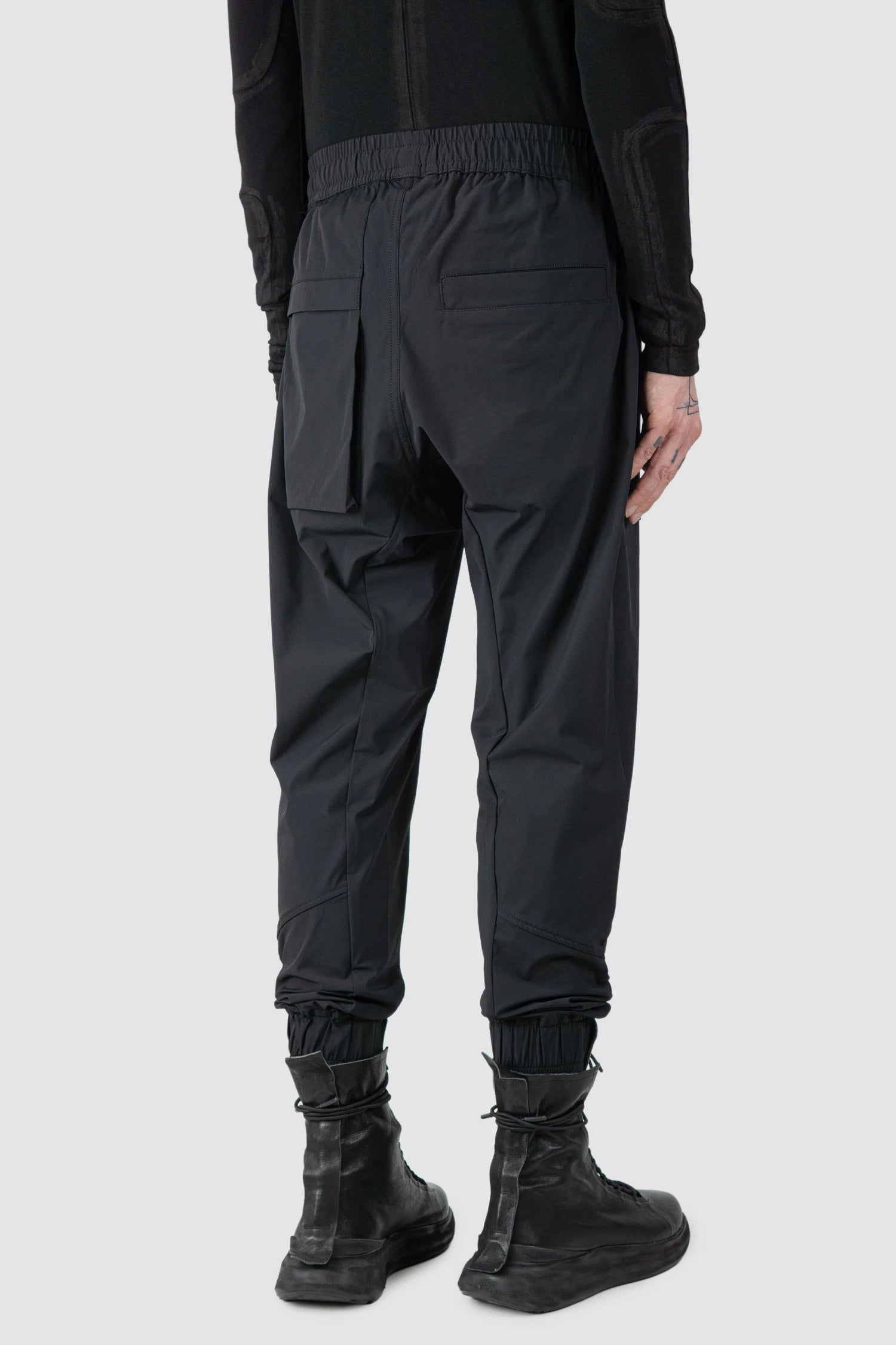 Thom Krom - model back side view of men’s FW25 Black Front Pocket Woven Stretch Cargo Trousers - M-P-27