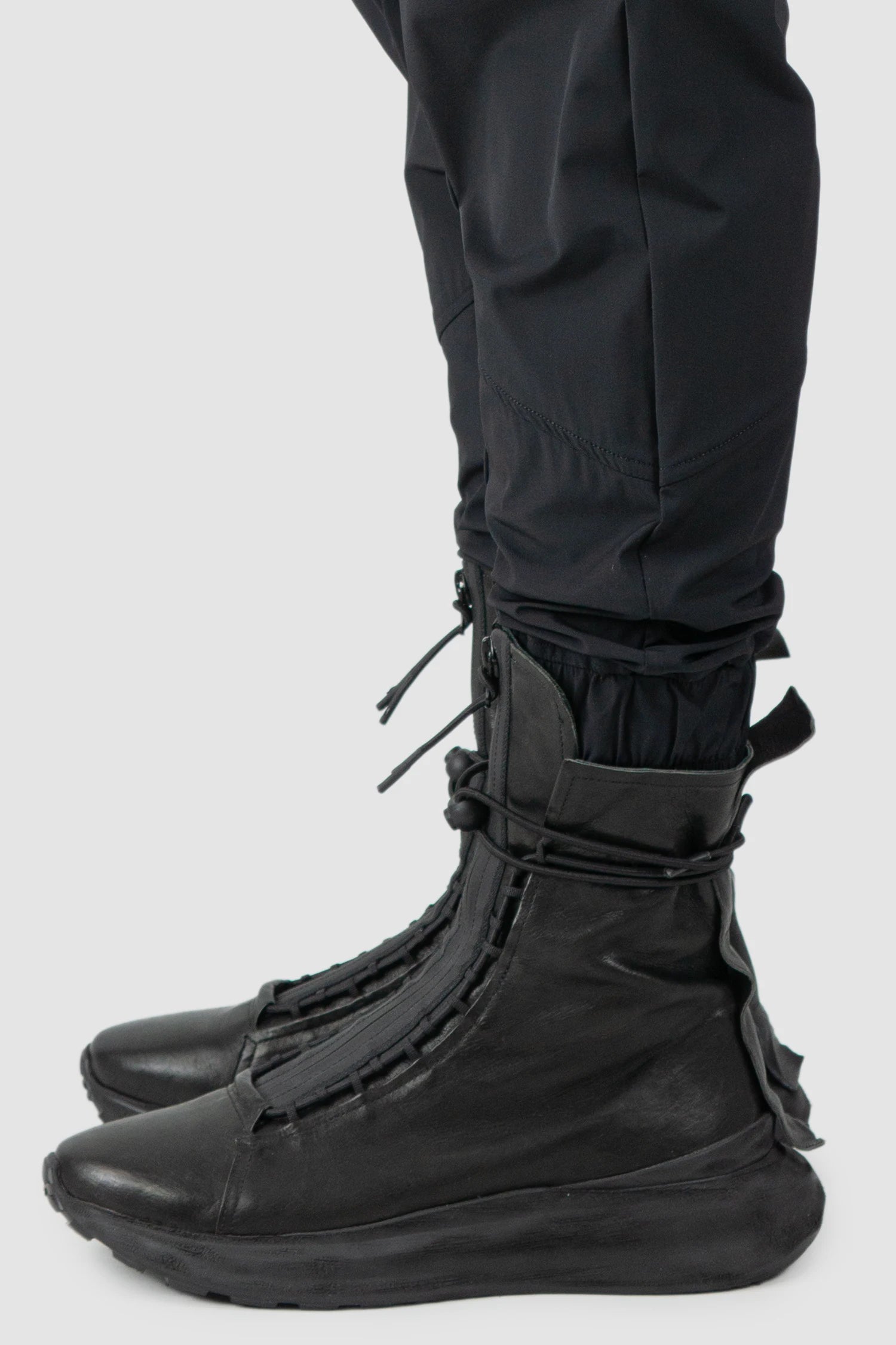 Thom Krom - model cuff detail view of men’s FW25 Black Front Pocket Woven Stretch Cargo Trousers - M-P-27