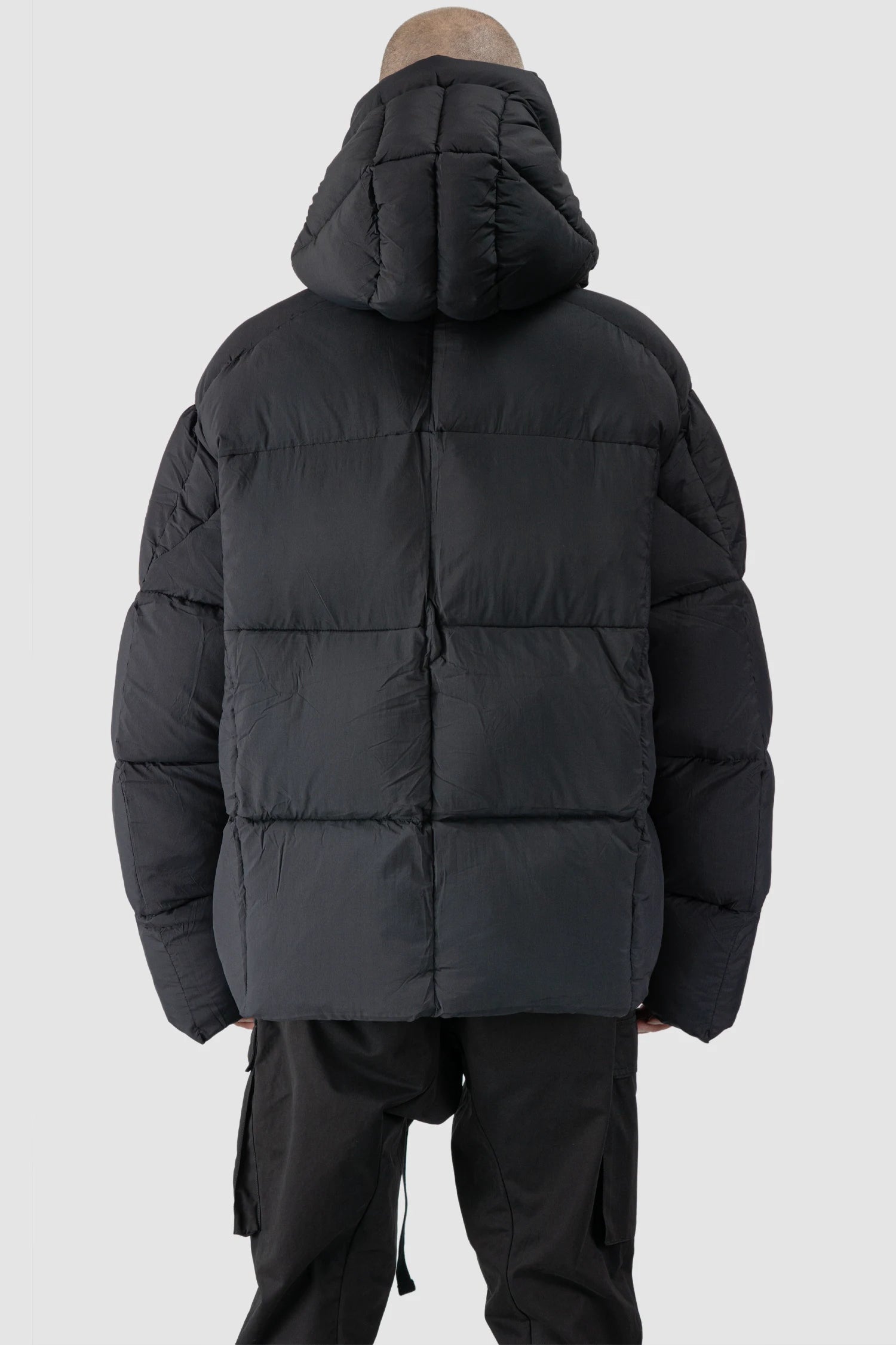 Thom Krom - model back view of men’s Black Guilted Nylon Puffer Jacket M-J-78