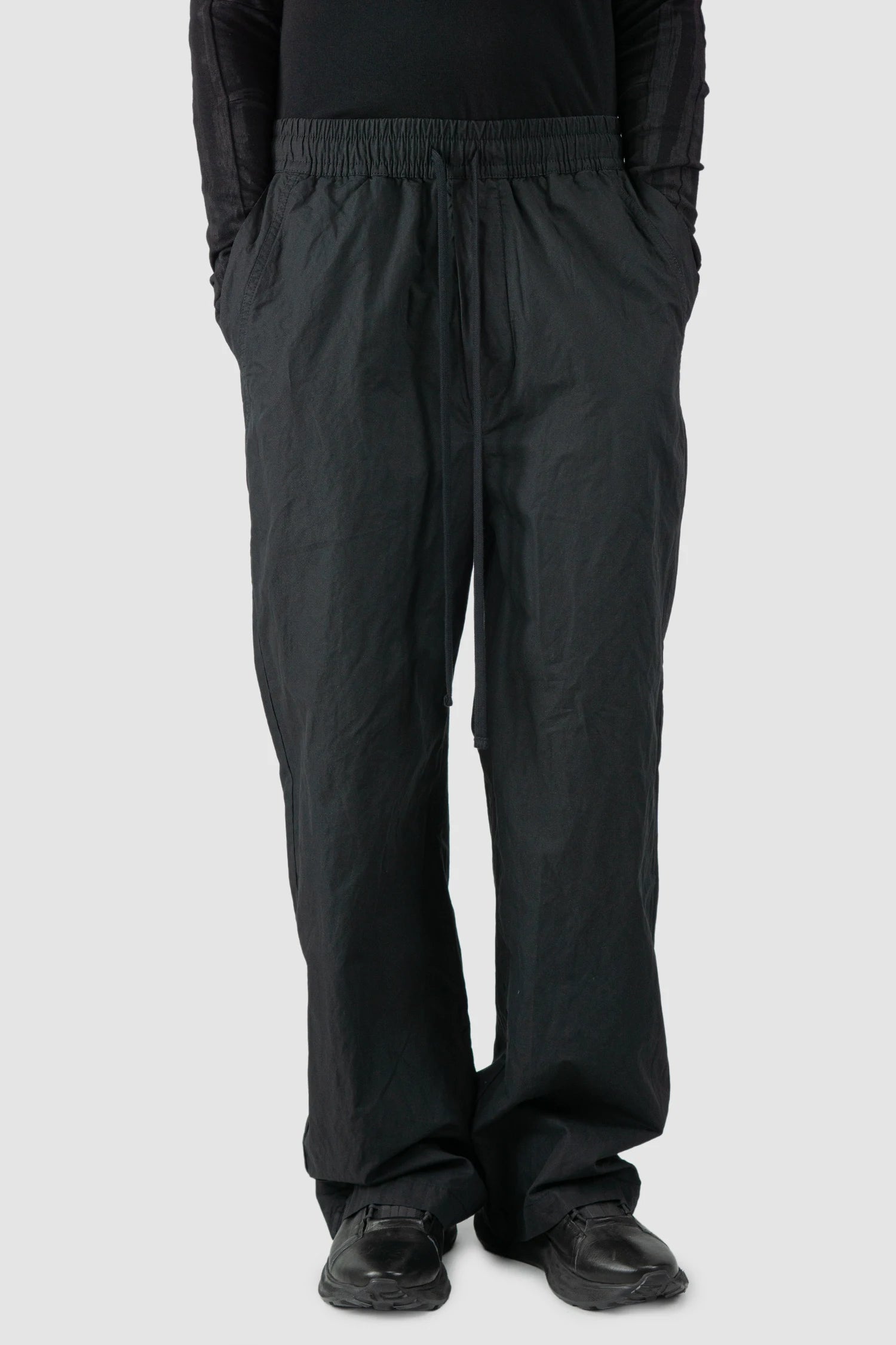 Thom Krom - model front relaxed view of men’s FW25 Black Metallic Wide Leg Cotton Trousers - M-P-19
