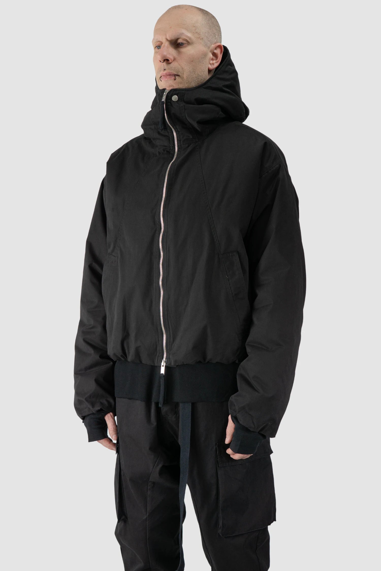 Thom Krom - model front side view of men’s Black Padded Short Jacket with Magnetic Buckle Hoody M-J-74